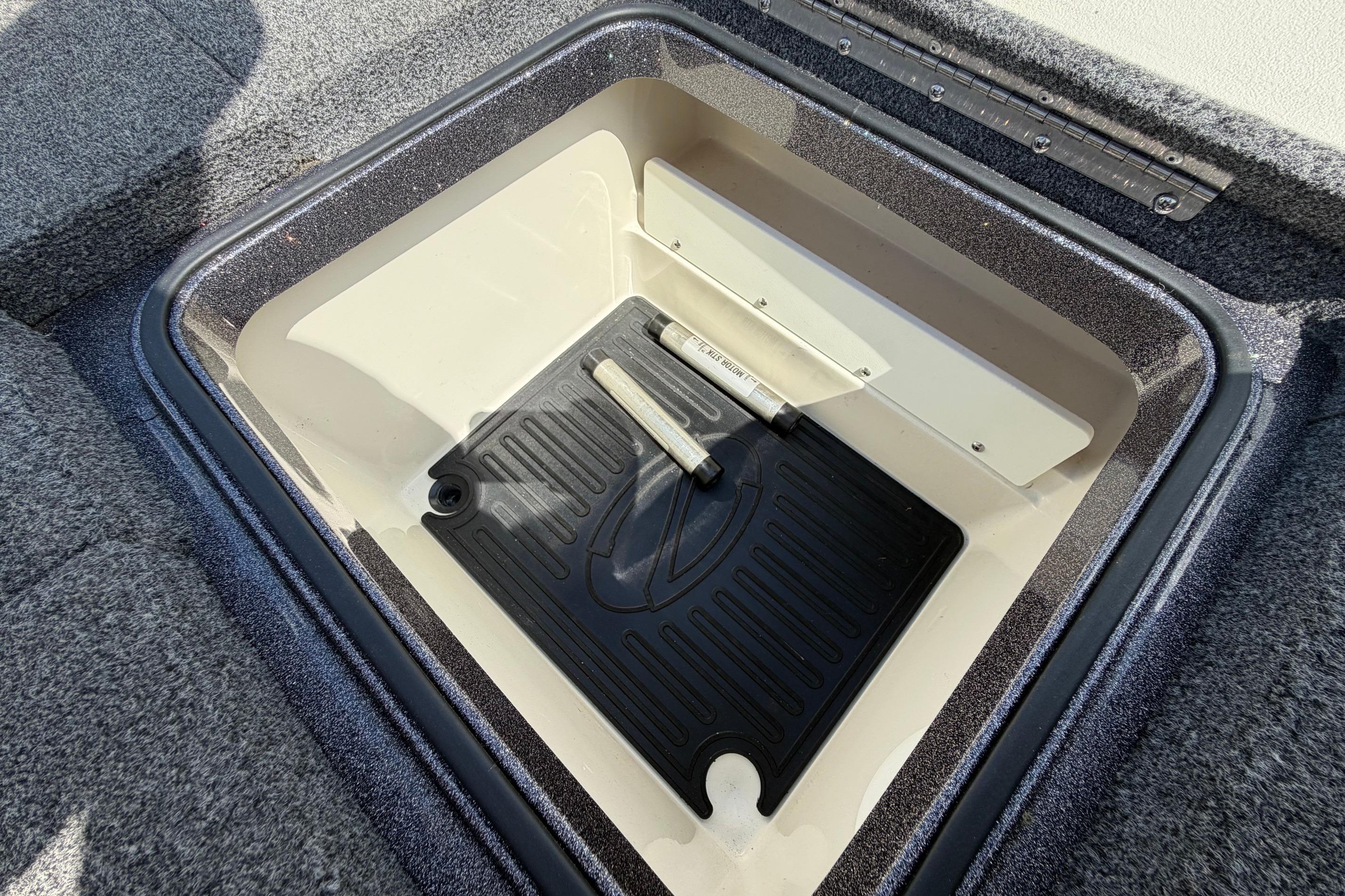 Storage compartment of a 2020 Ranger Z520L boat, featuring a black mat and gray interior.