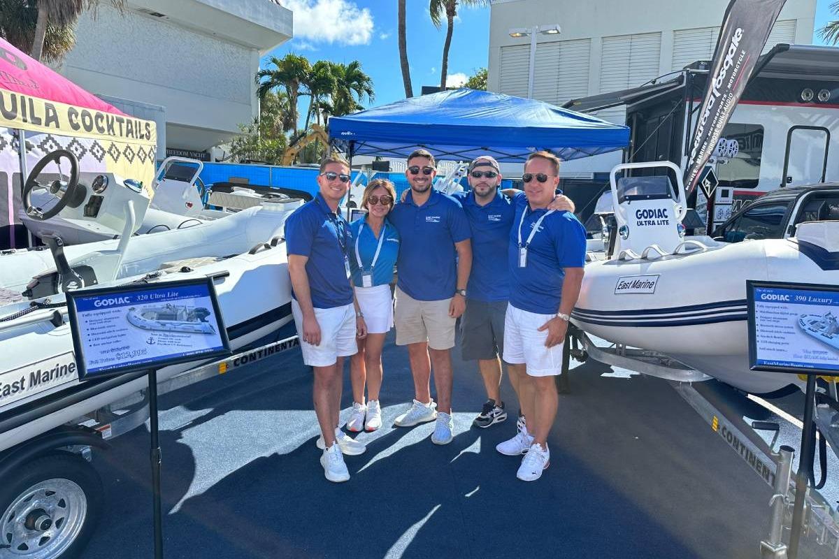 Group showcasing East Marine 300 boat at outdoor event, 2026 model.