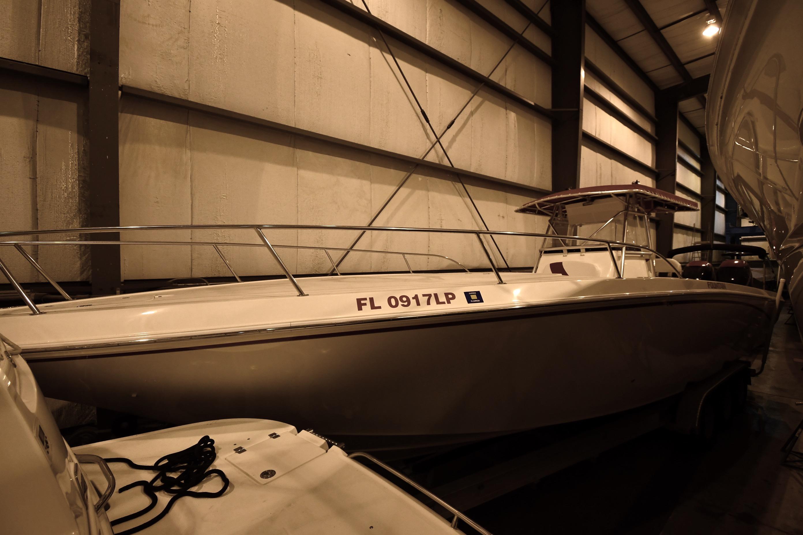 2001 Fountain 38 Center Console boat stored indoors, side view.