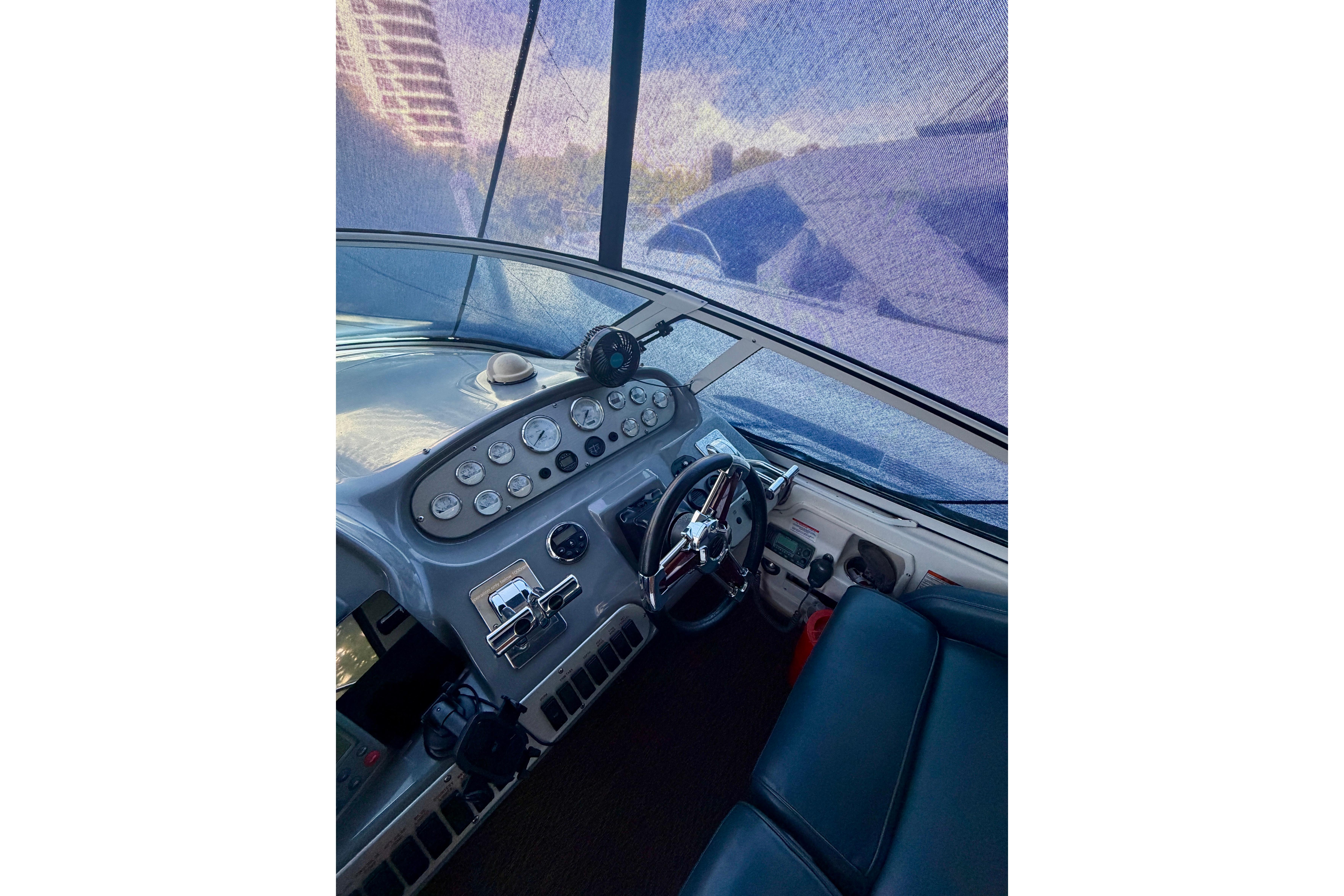2007 Cruisers Yachts 370 Express helm with steering wheel and control panel.