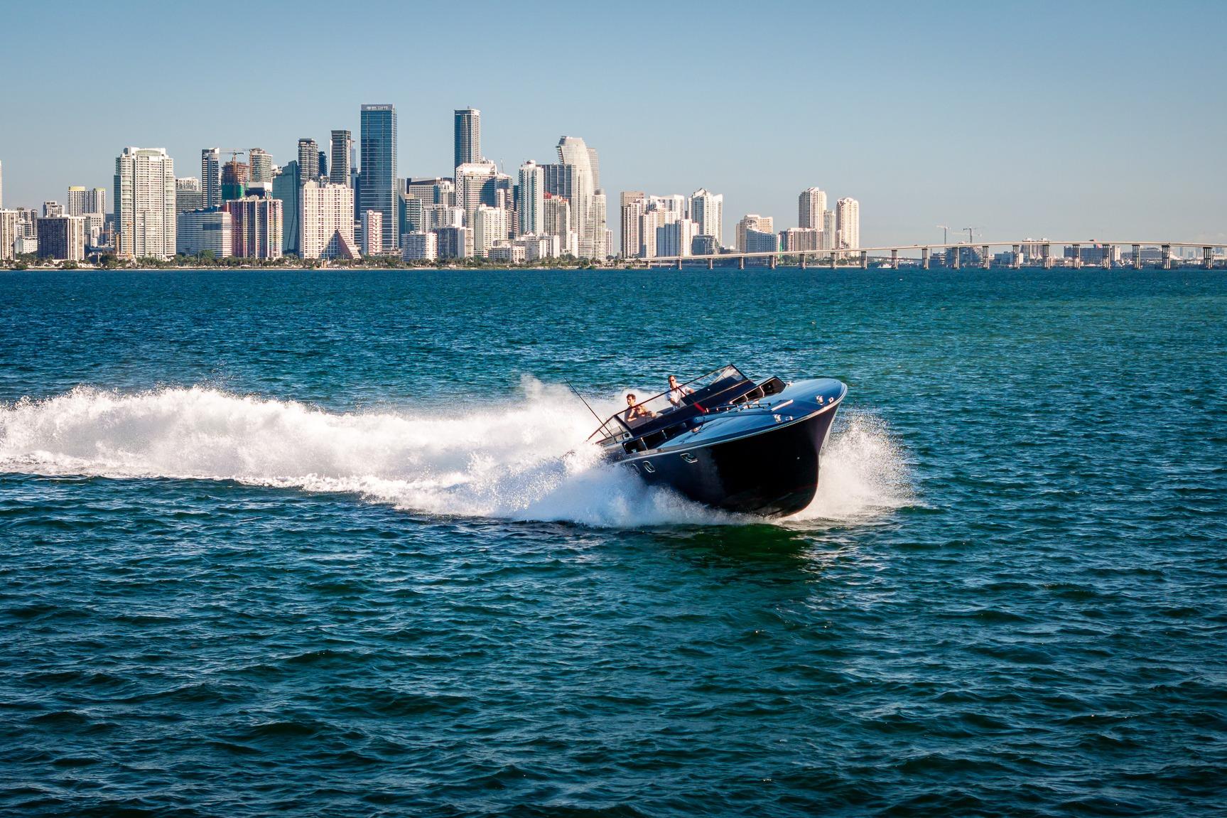 Magnum 50 Bestia boat cruising near city skyline, 2000 model.