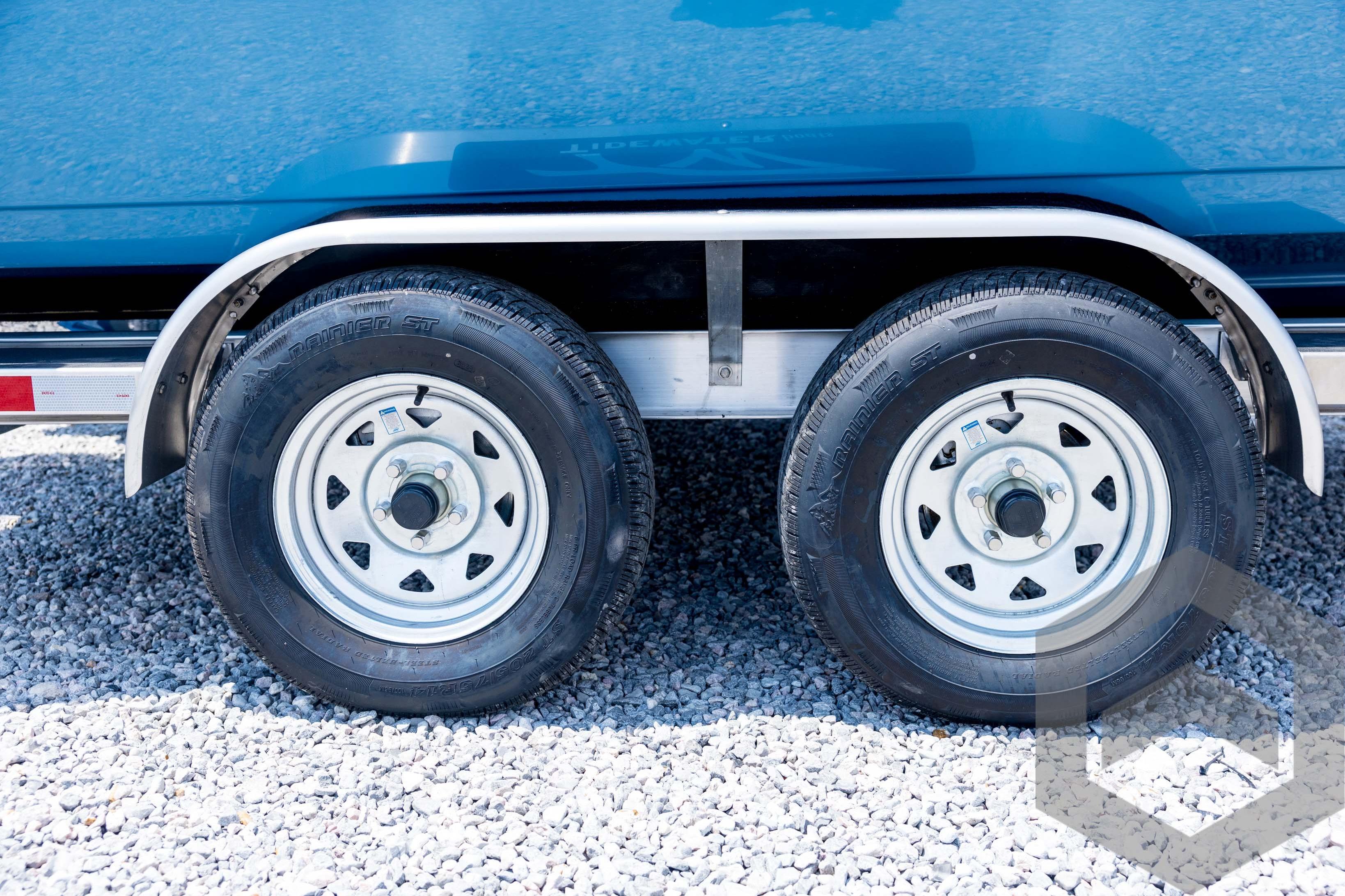 2026 Tidewater 2110 Bay Max trailer wheels on gravel surface.