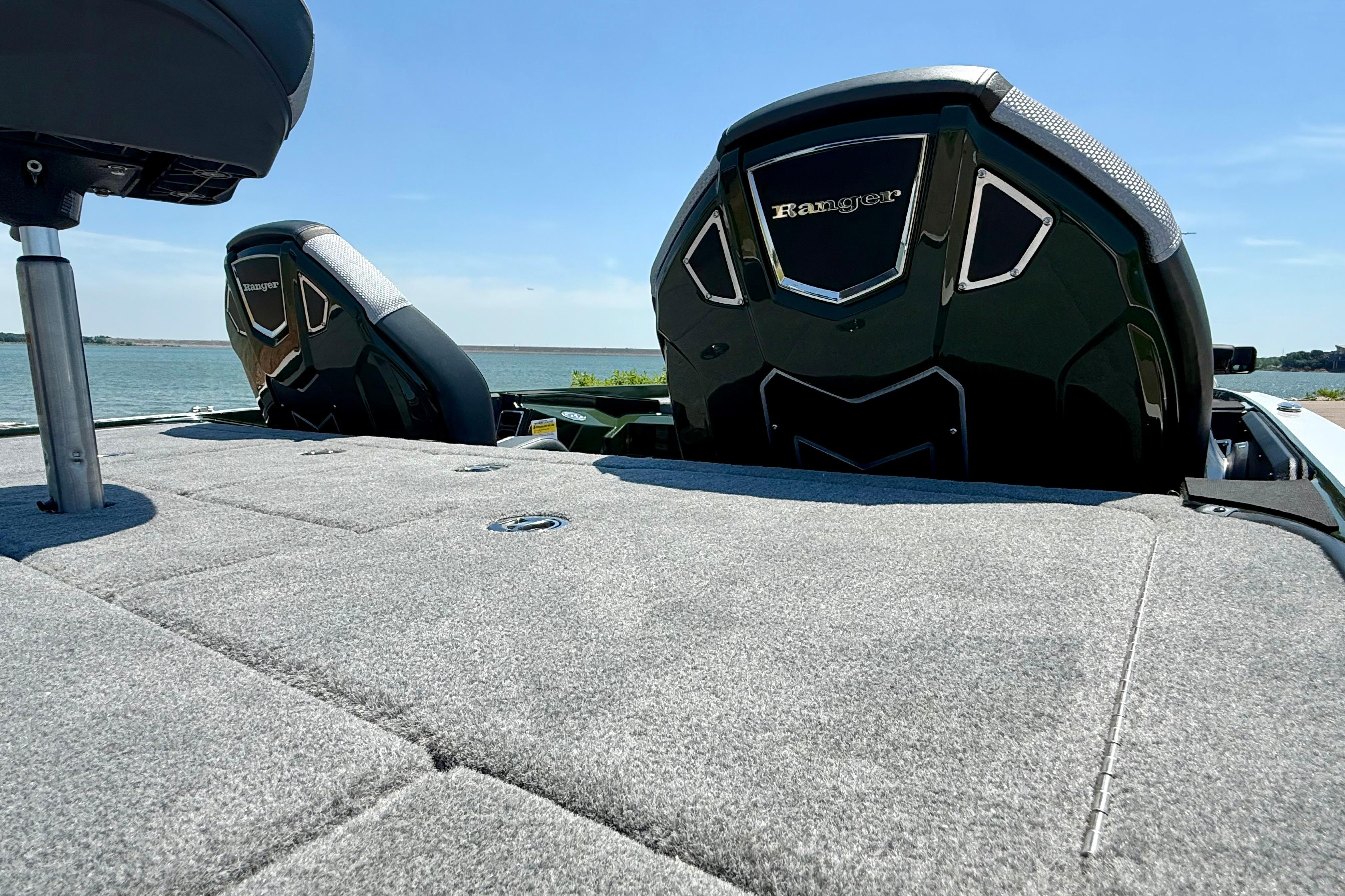 2026 Ranger Z519R boat with plush carpeted deck, dual seats, and scenic lake view.