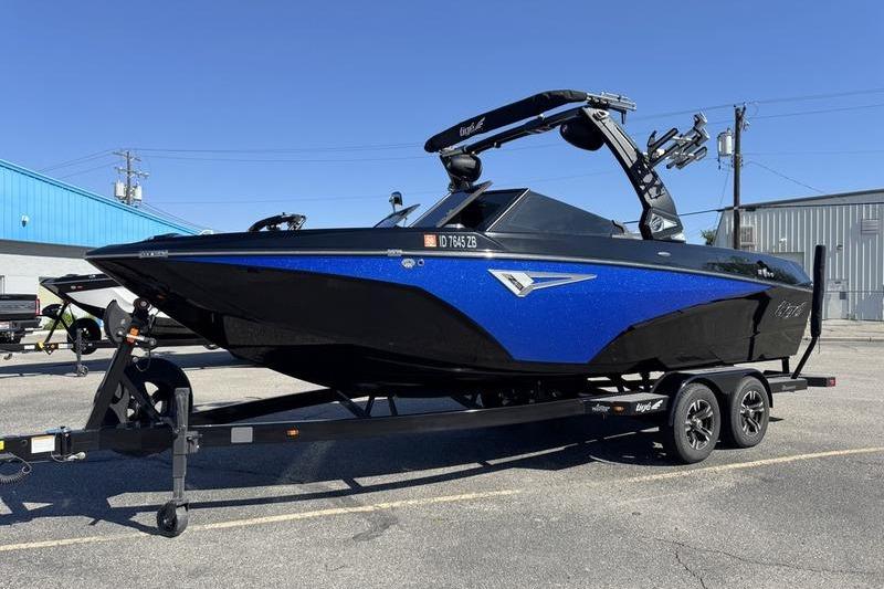 2022 Tigé Z3 boat in blue and black on a trailer, parked outdoors.
