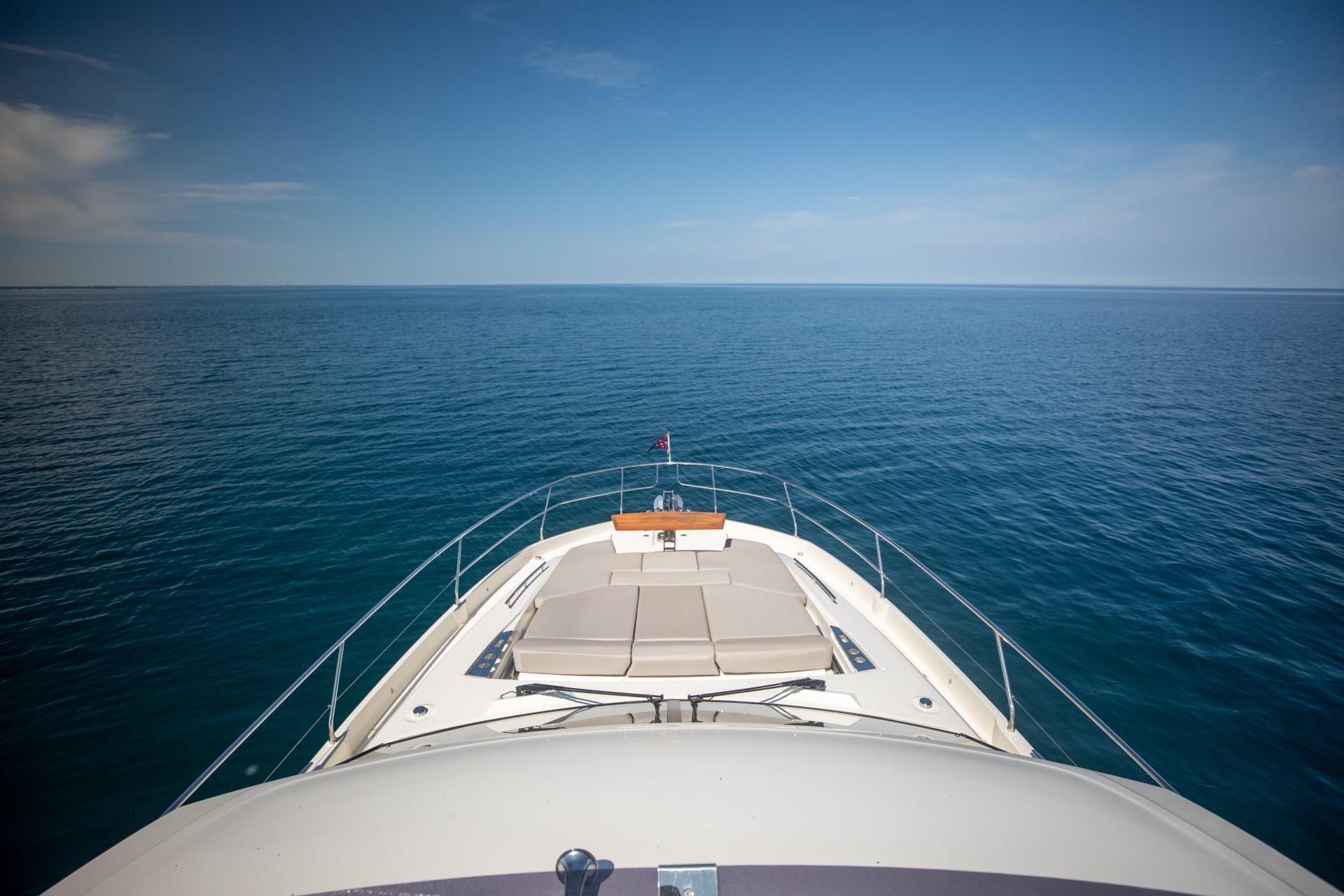 Prestige 590 Flybridge Cruiser 2020 on open sea, showcasing luxury and expansive ocean view.