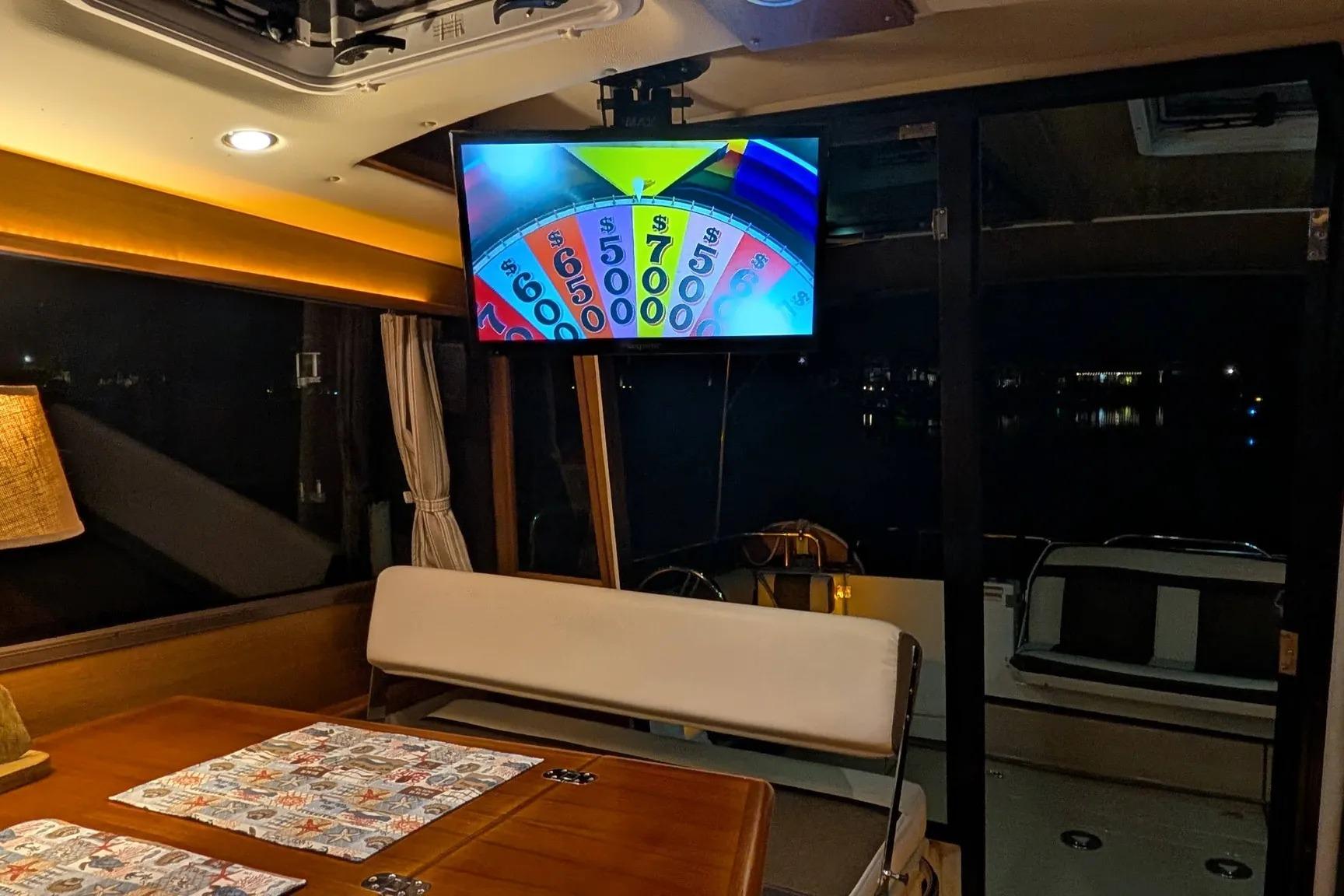 Interior of 2015 Ranger Tugs R-29 S with TV showing game show.