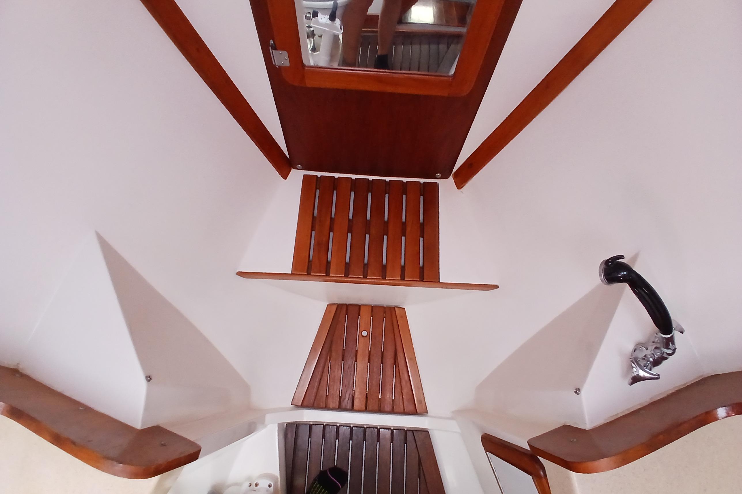 Interior of 1995 Catalina 42 MkII sailboat, featuring wooden steps and nautical design elements.