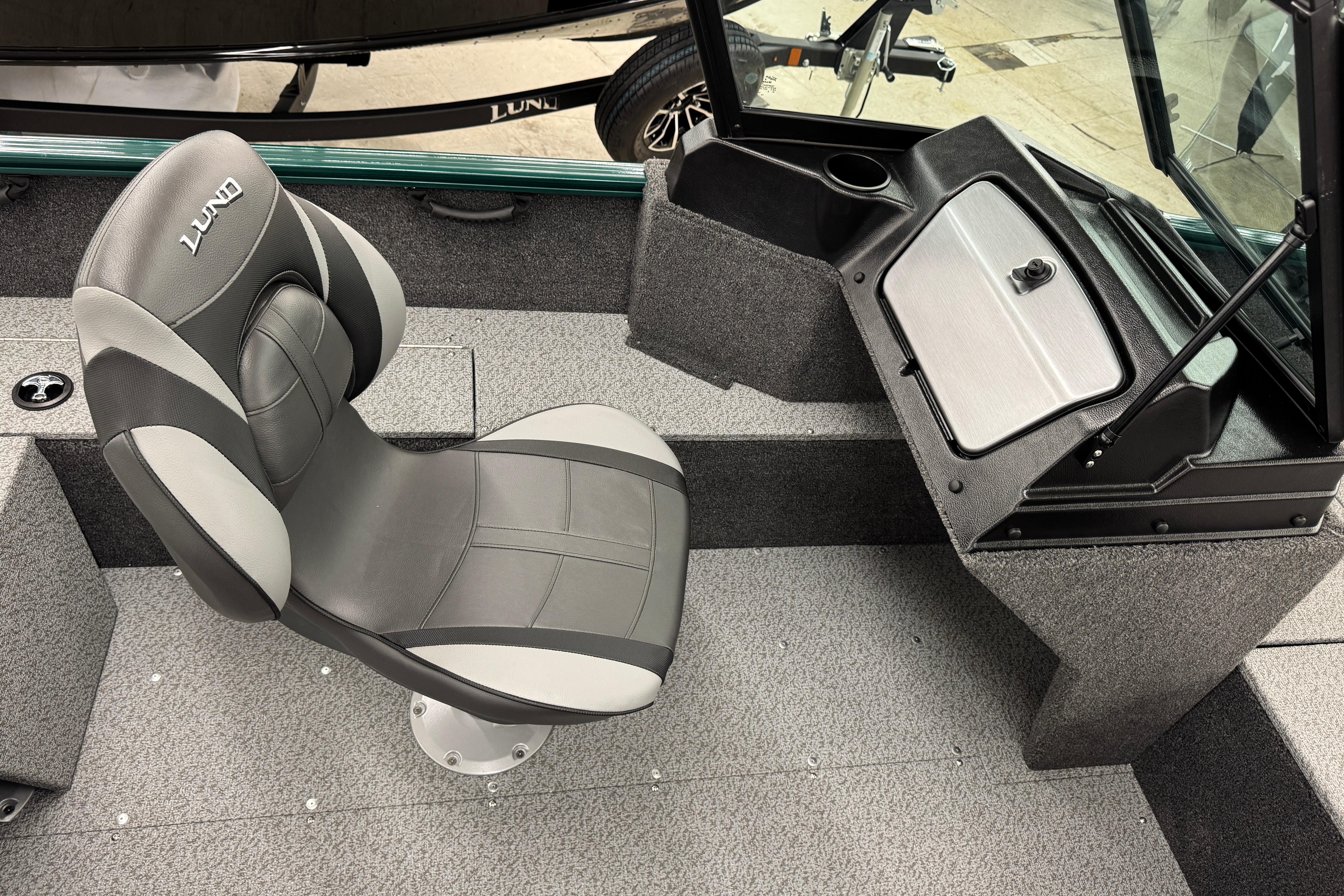 2026 Lund 1650 Rebel XL Sport boat interior with gray seating and storage compartment.
