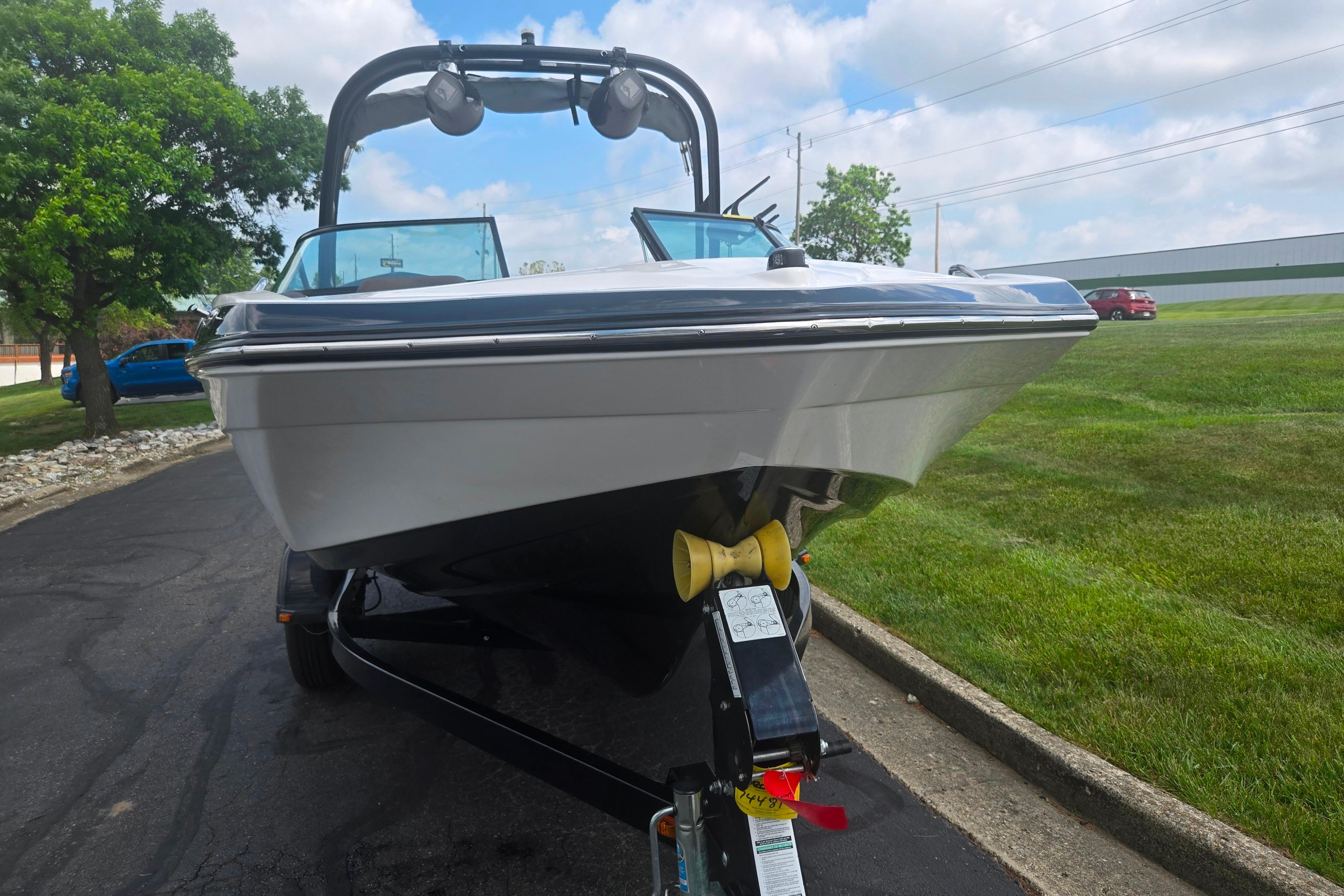 2016 Yamaha Boats AR192 on trailer, parked on paved road with grassy surroundings.