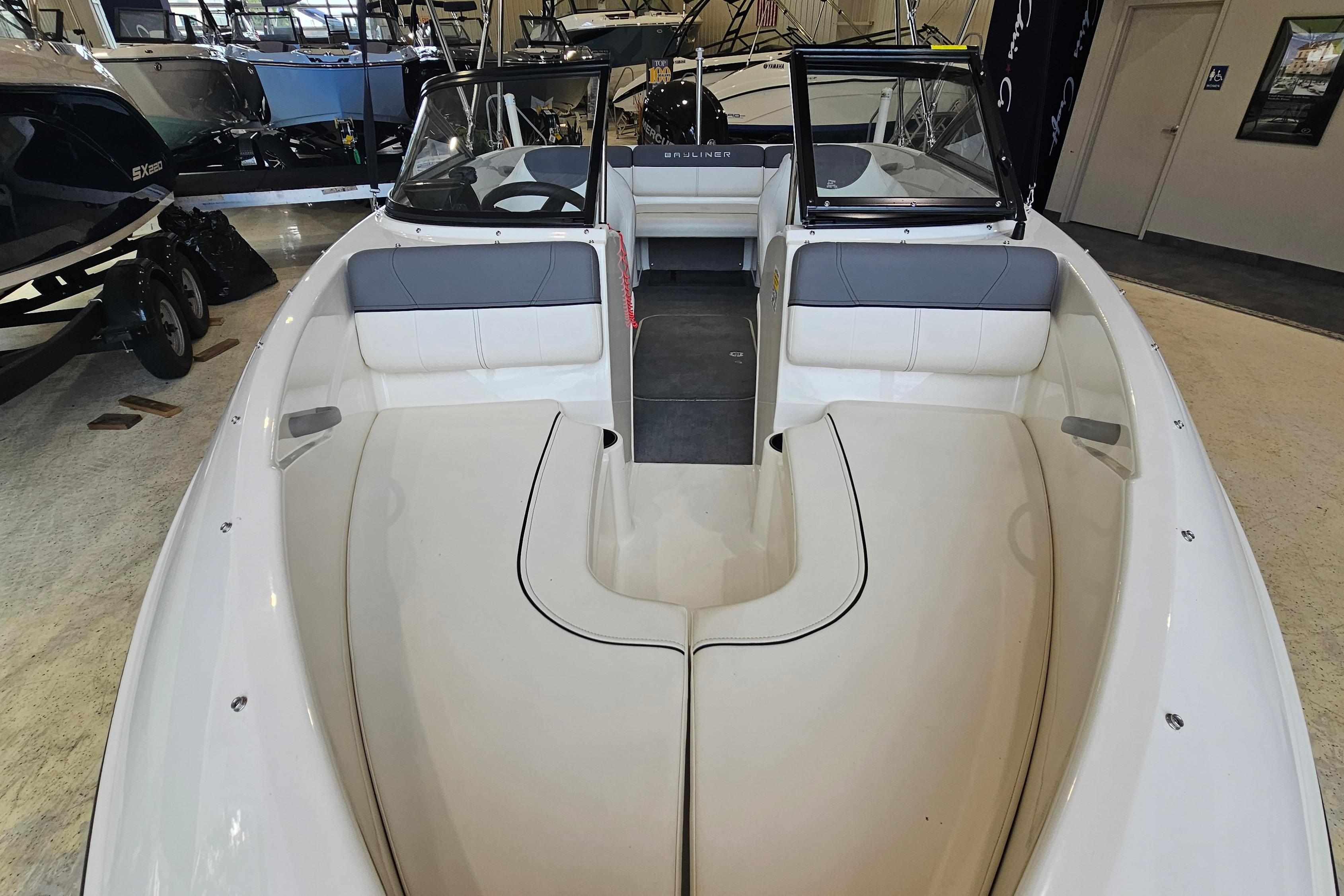 2019 Bayliner 170 Bowrider interior view, showcasing seating and cockpit area in showroom.