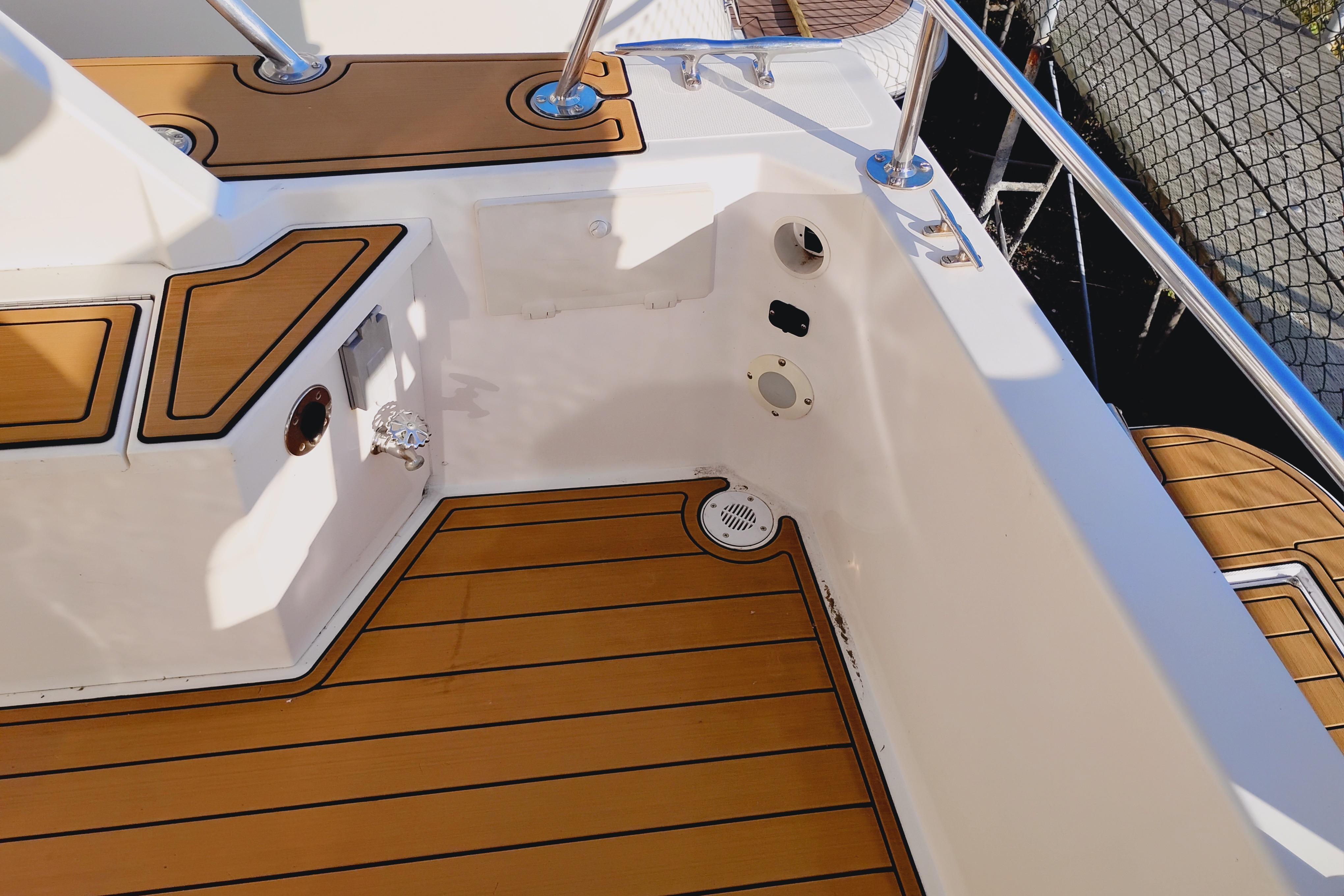 Canoe Cove 50 Pilothouse Motor Yacht 2002, featuring teak deck and stainless steel railings.