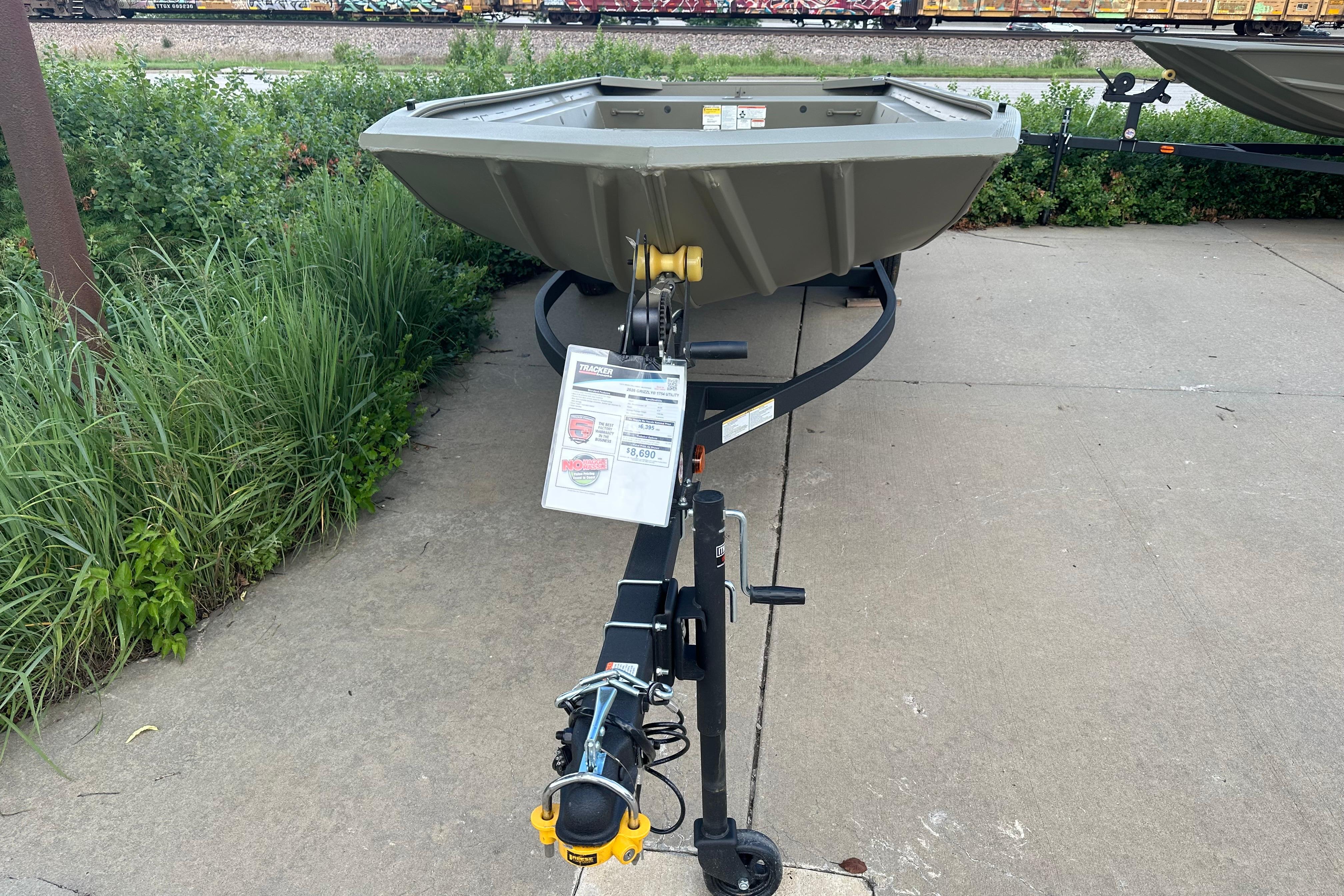 2026 Tracker Grizzly 1754 Utility boat on trailer, displayed outdoors.