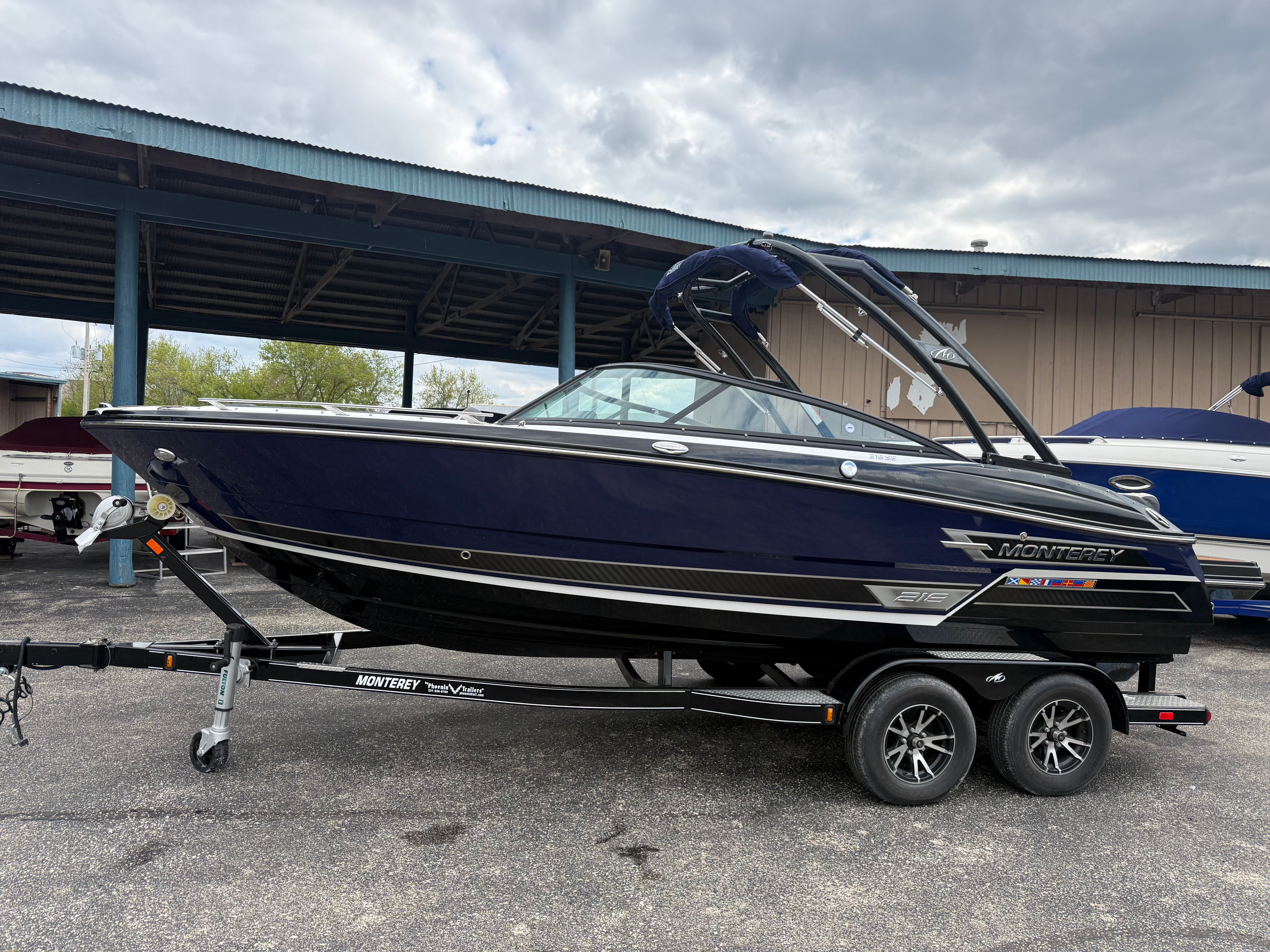 2021 Monterey 218 Super Sport boat on trailer, side view.