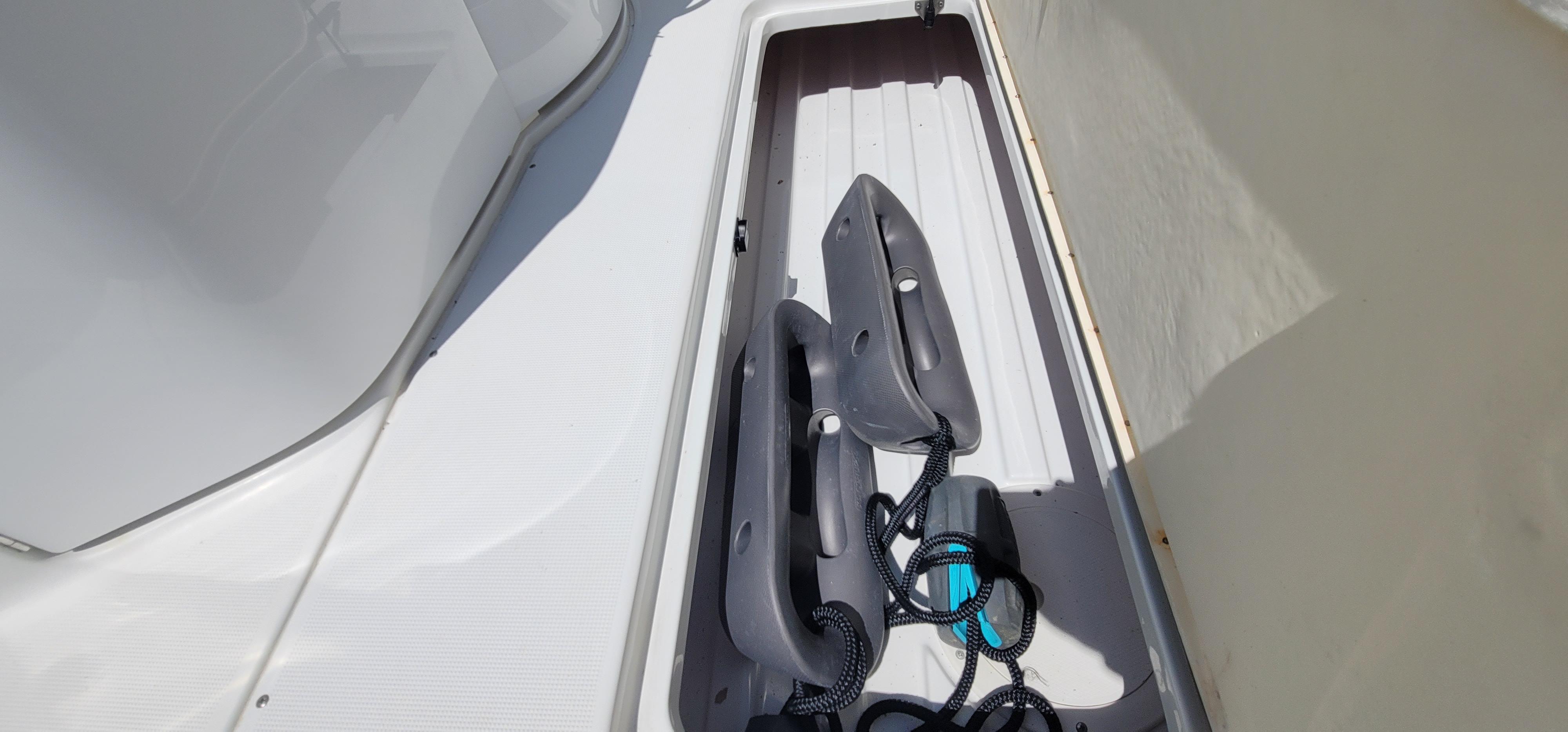 Storage compartment on a 2007 Formula 330 Sun Sport boat with fenders and ropes.