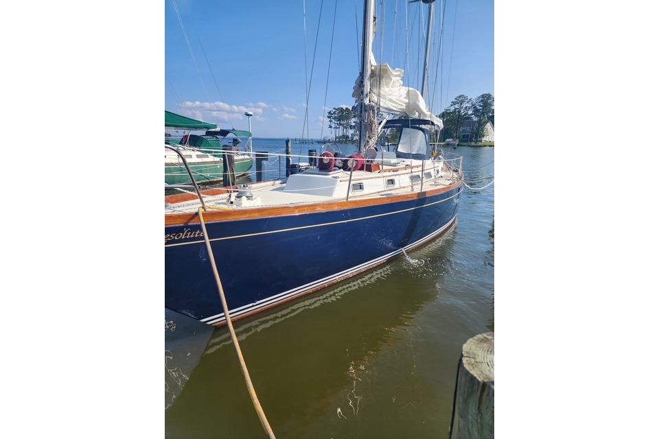 1984 Bristol 45.5 Center Cockpit sailboat docked in a serene marina setting.