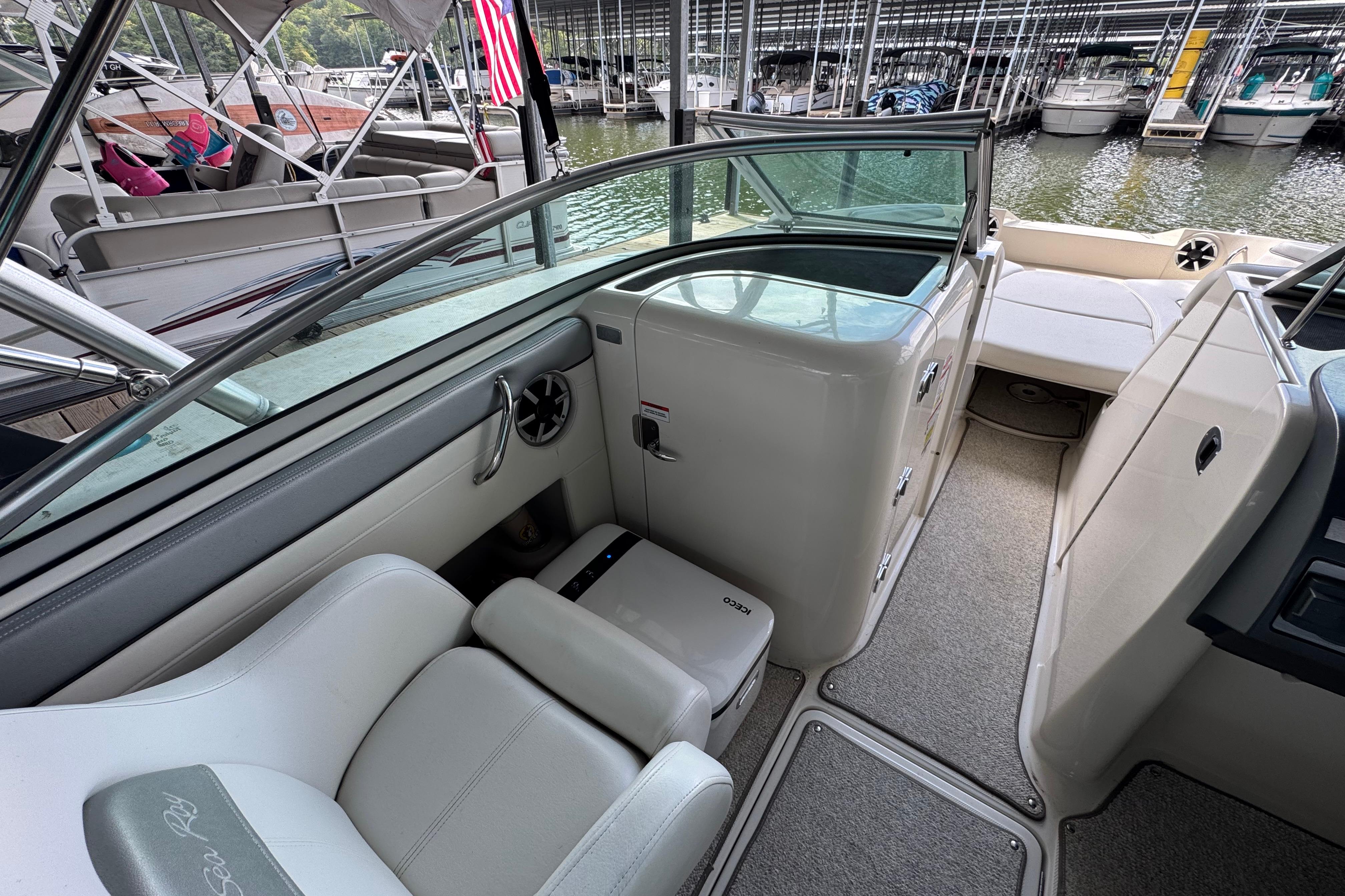 2009 Sea Ray 280 Sundeck interior with seating and storage, docked at marina.