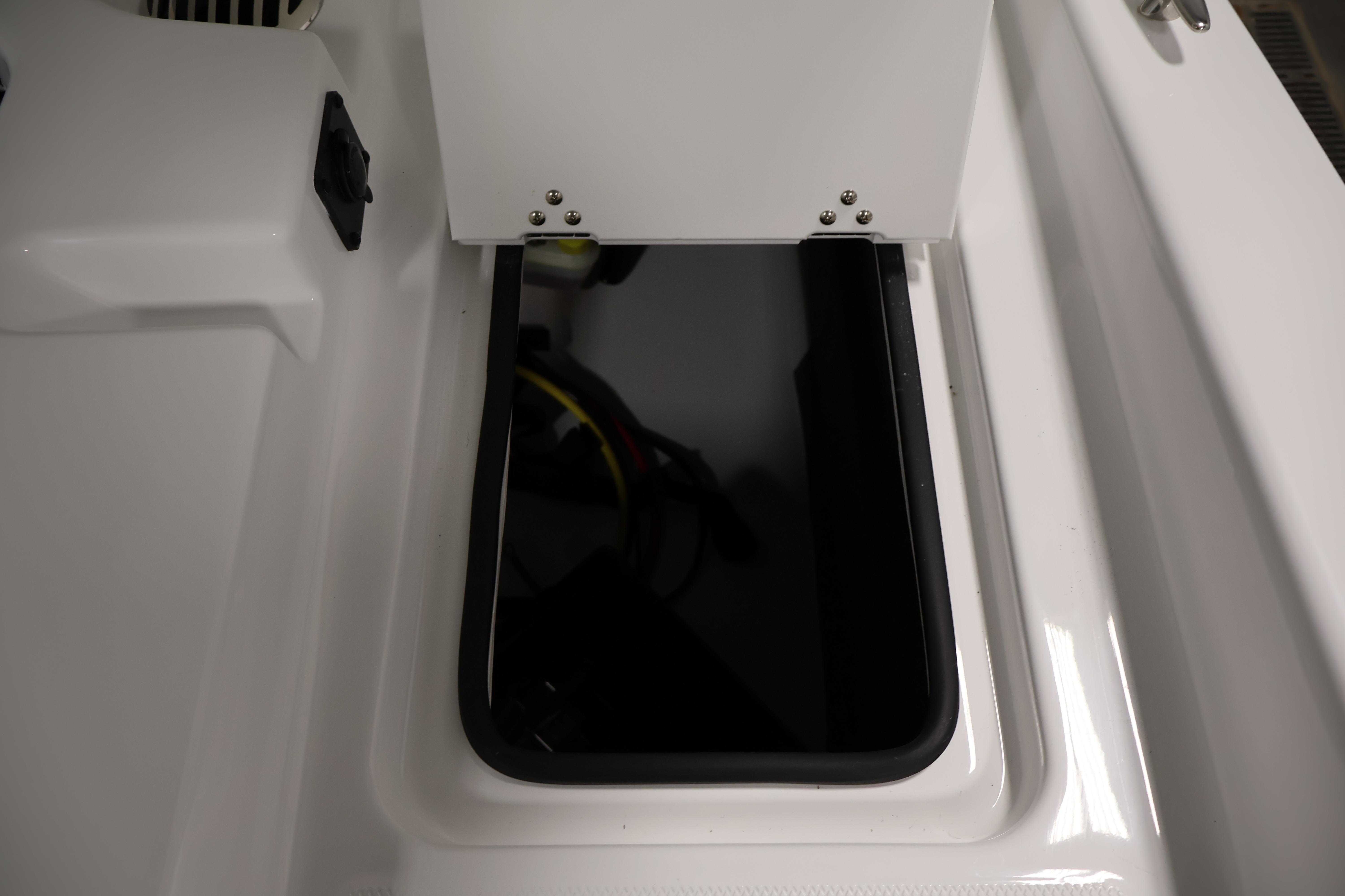 Storage compartment on 2026 Four Winns H4 Freedom boat, featuring sleek white design.