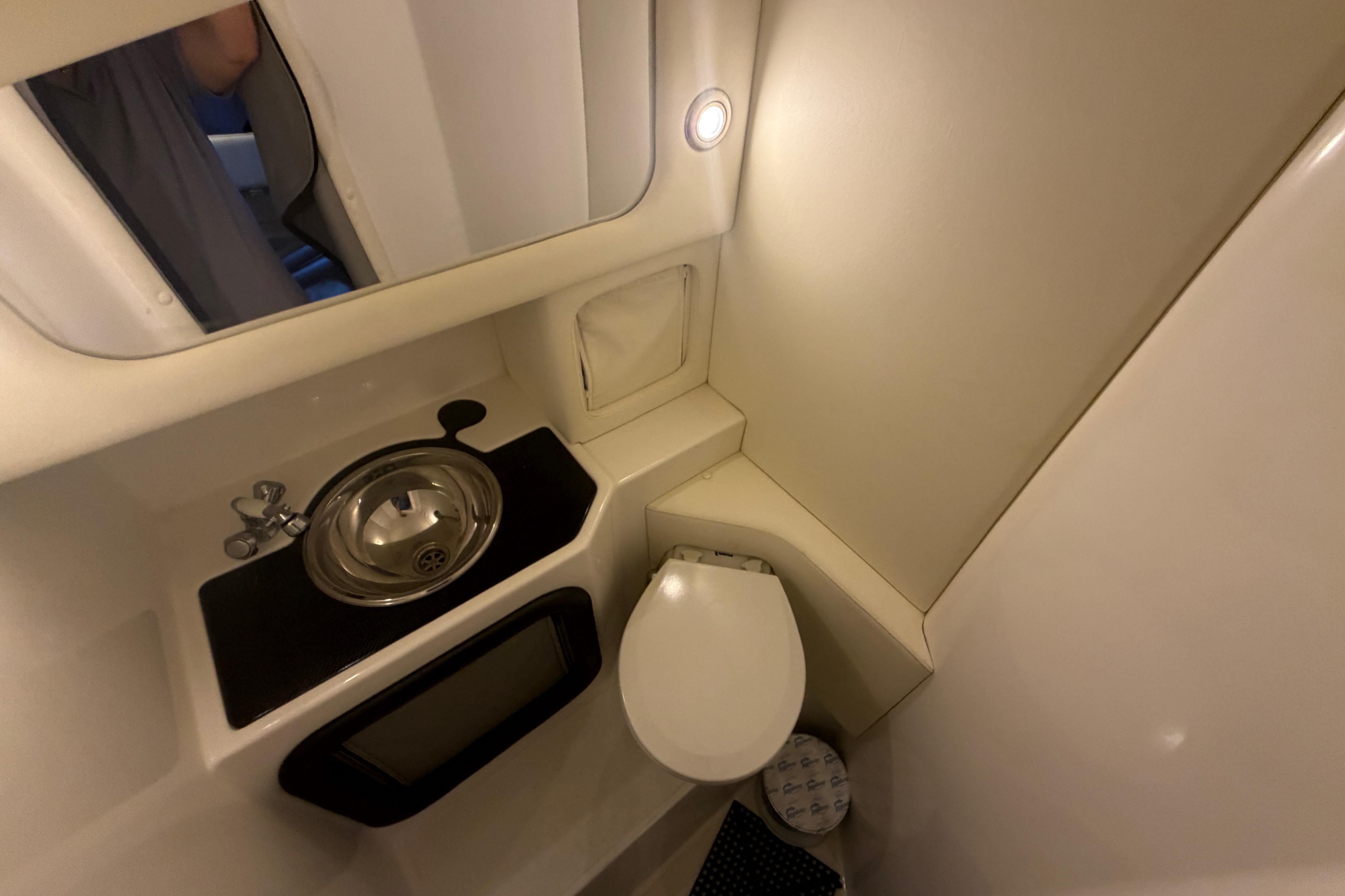 Compact bathroom in 2013 Nor-Tech 477 SPX Vee Bottom boat, featuring sink and toilet.