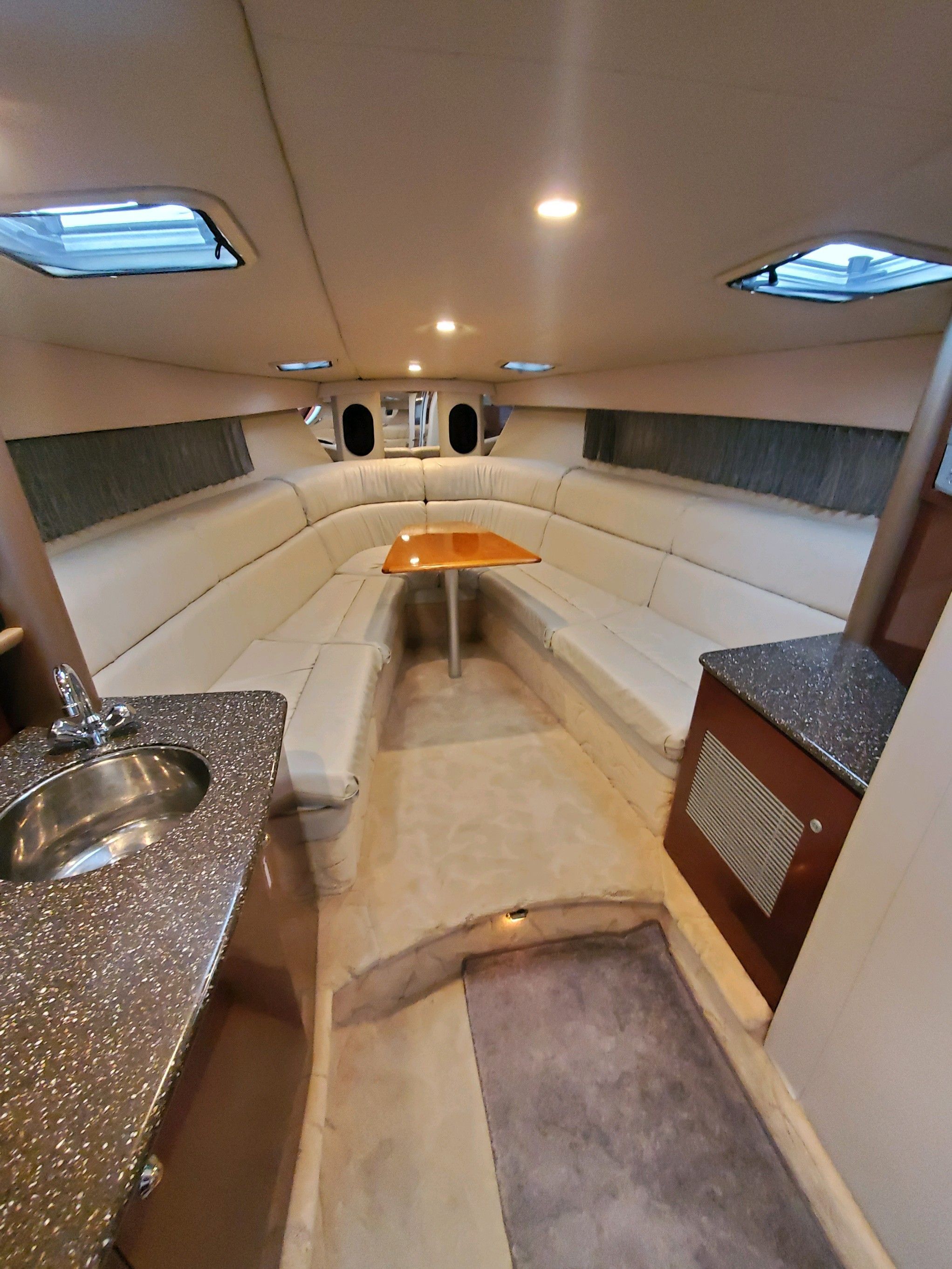 Interior of the 2004 Formula 370 Super Sport with elegant seating area and table.