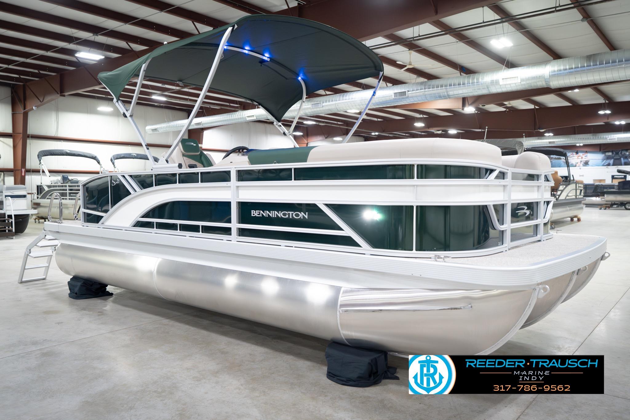 2026 Bennington 20 SLJ pontoon boat in showroom with canopy and sleek design.