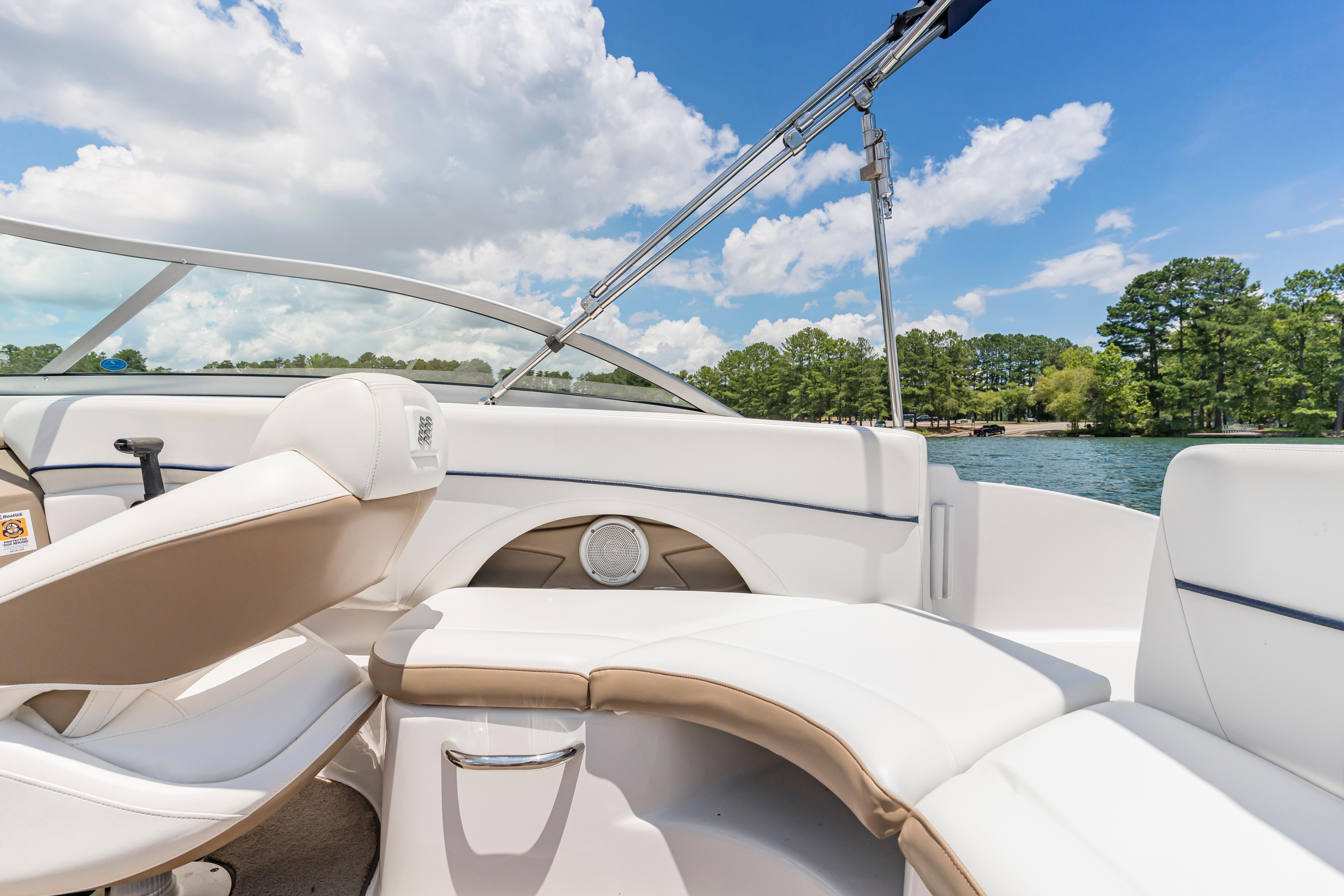 2008 Four Winns F224 boat interior with white seating, on a sunny lake day.