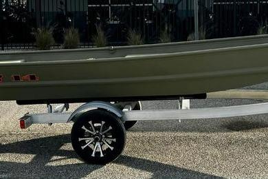 2026 Tracker Grizzly 14 Jon boat on a trailer, side view.