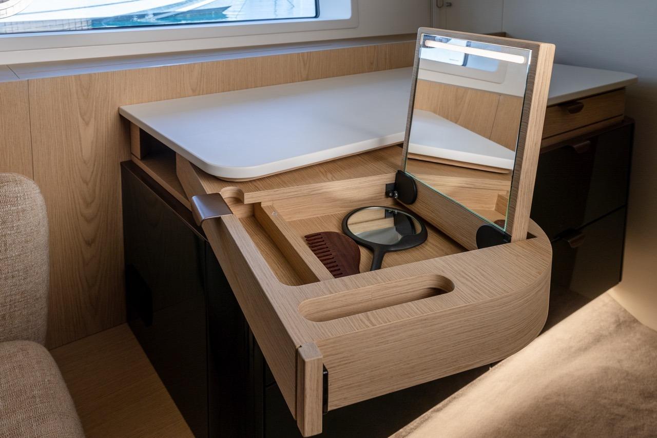 Luxurious vanity area on 2025 Azimut Fly 62 yacht with mirror and accessories.