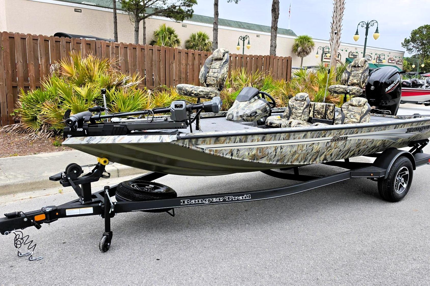 2026 Ranger RT178 fishing boat with camouflage design on a trailer, parked outdoors.