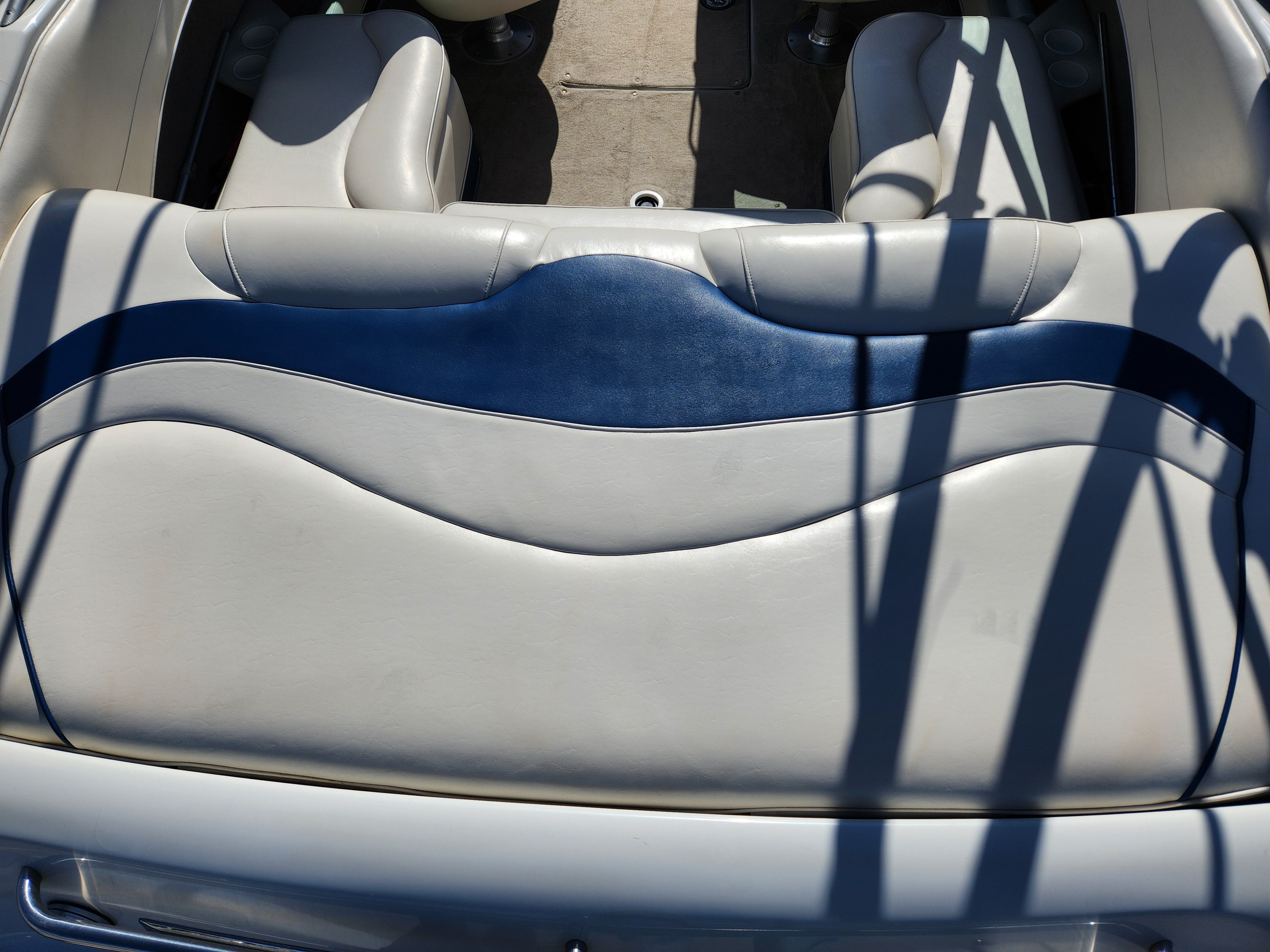 Interior of a 2003 Crownline 225 BR boat with blue and white seating.