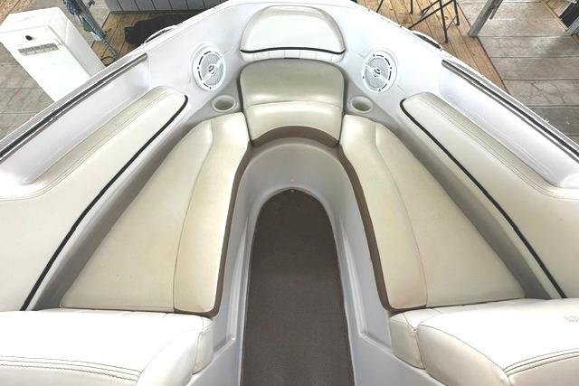 2007 Four Winns 200 Horizon boat interior with white cushioned seating and built-in speakers.