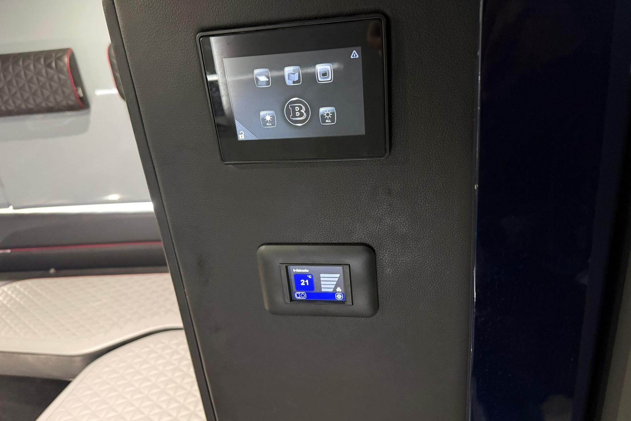 Control panel inside 2022 Axopar Brabus Shadow 900 Sun-Top boat, featuring digital displays.