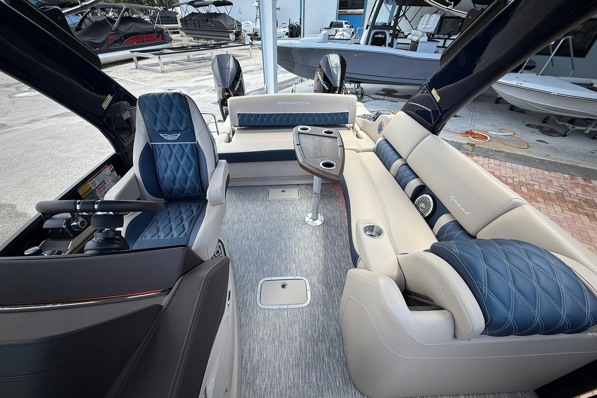 Luxurious interior of 2026 Bennington 27 QSBAT2 pontoon boat with plush seating and modern design.