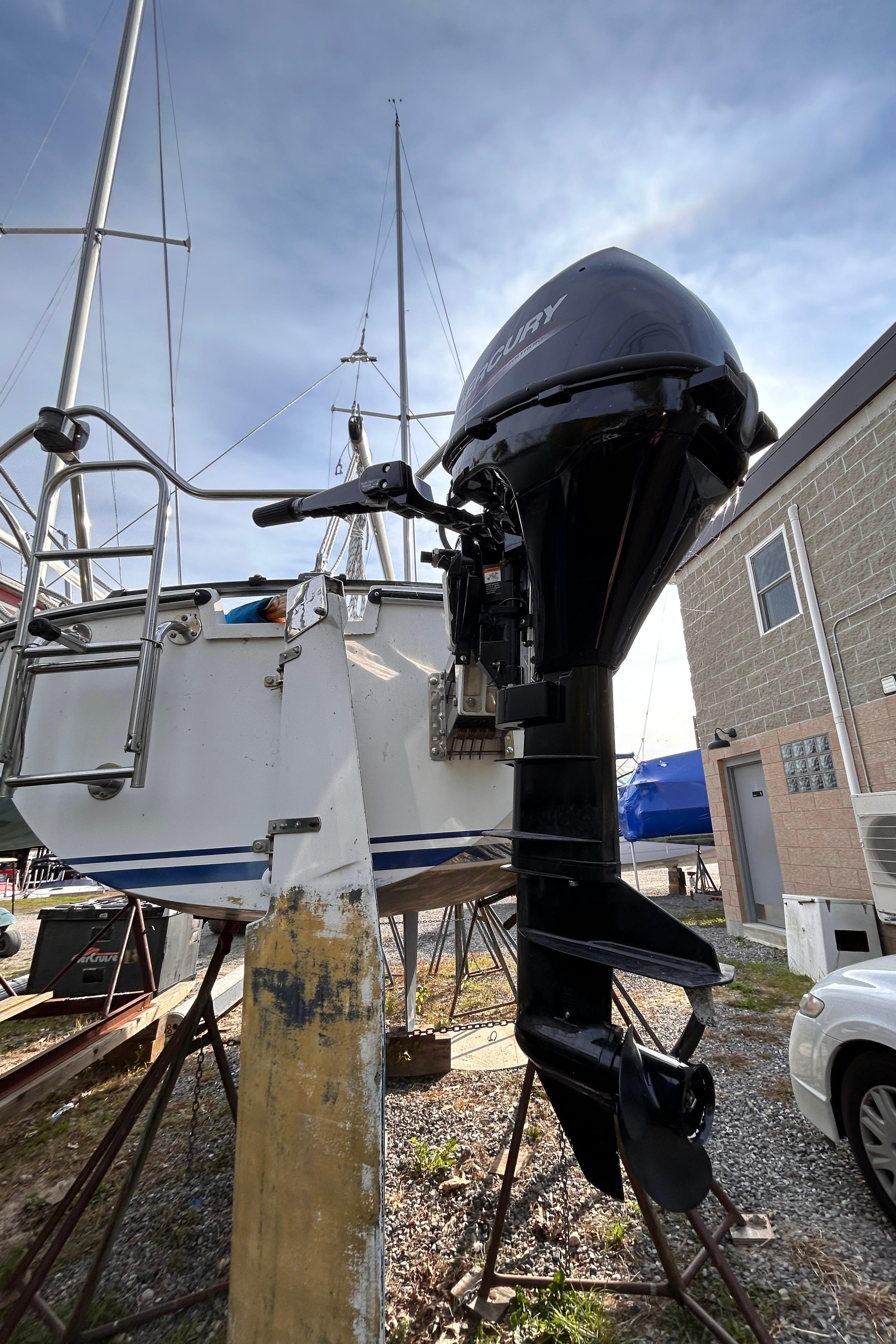 Outboard motor on a 1986 CAL 22 sailboat in a boatyard.