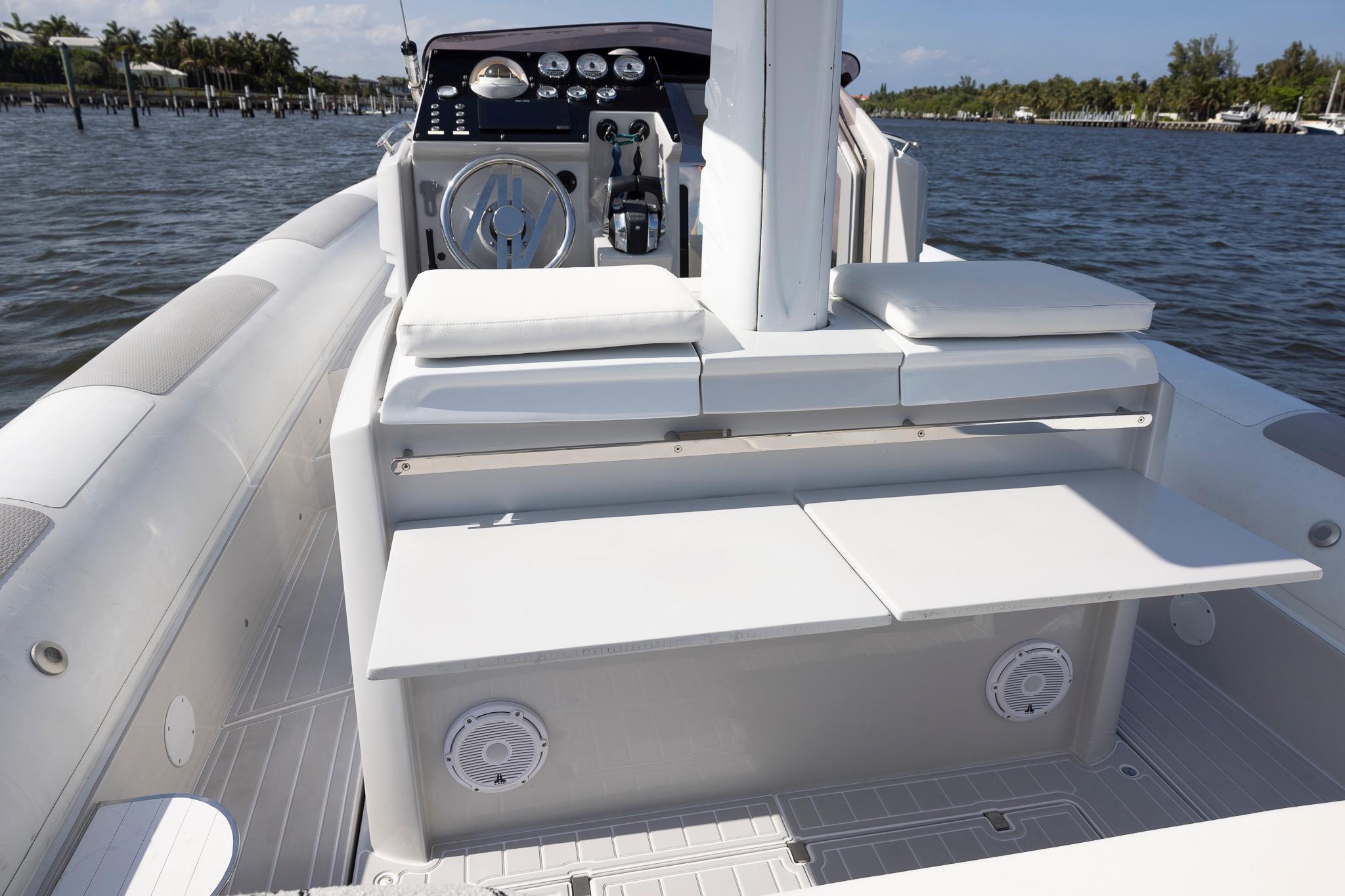 2013 Zeta Elle 34 Custom boat interior with seating and control panel on water.