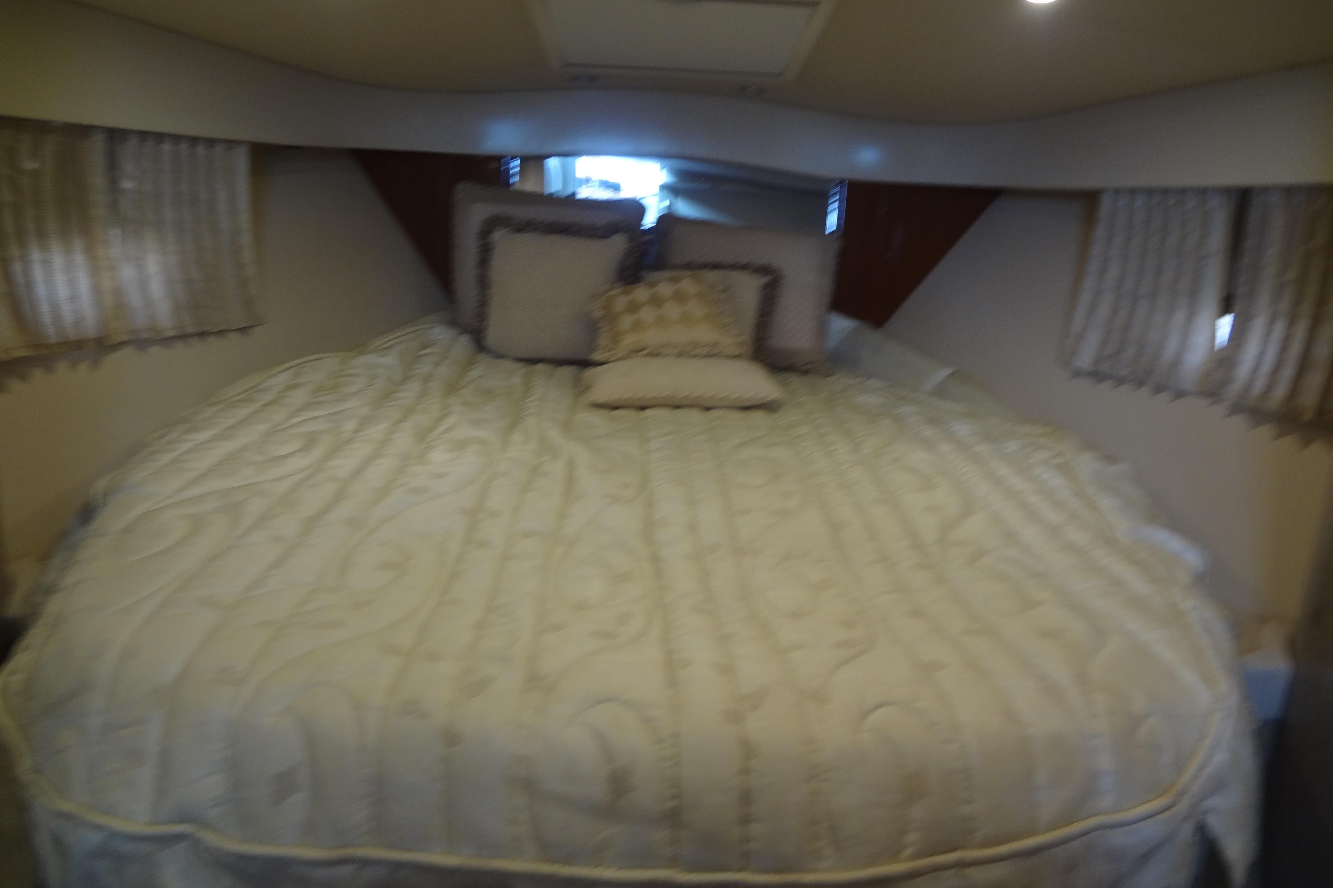 Luxurious bedroom interior of 2007 Formula 34 Performance Cruiser with elegant bedding.