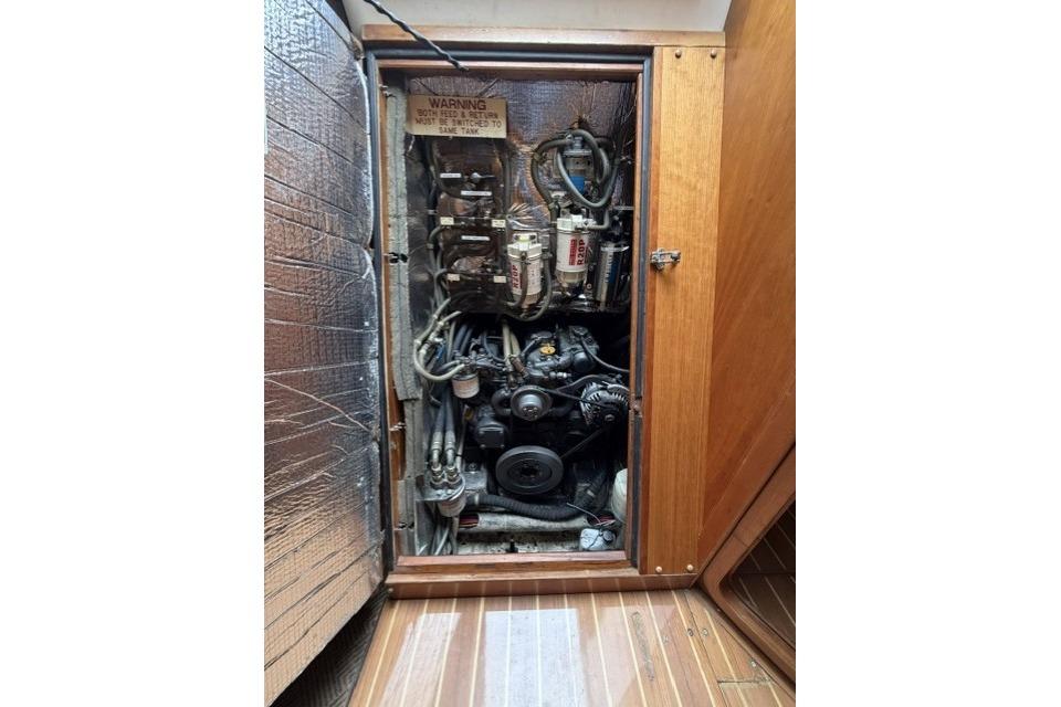 Engine compartment of a 2002 Saga 43 sailboat, showcasing mechanical components and wiring.