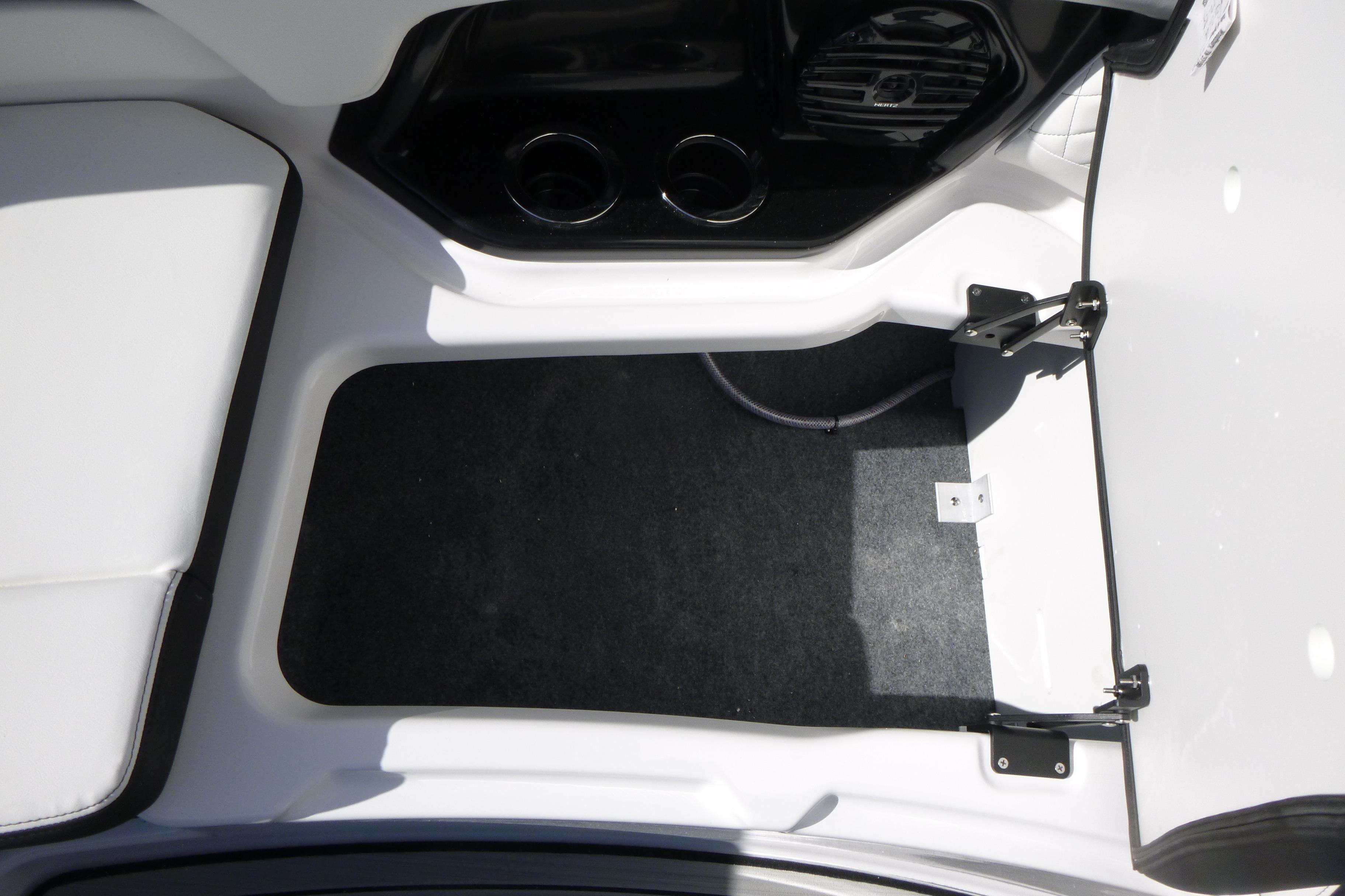 Interior view of 2026 Yamaha Boats 252SD, featuring storage compartment and cup holders.