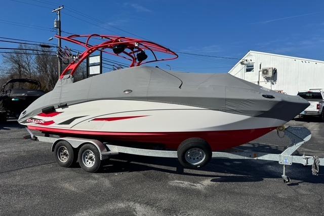 2020 Yamaha Boats 242X E-Series on trailer, covered, with red accents, parked outdoors.
