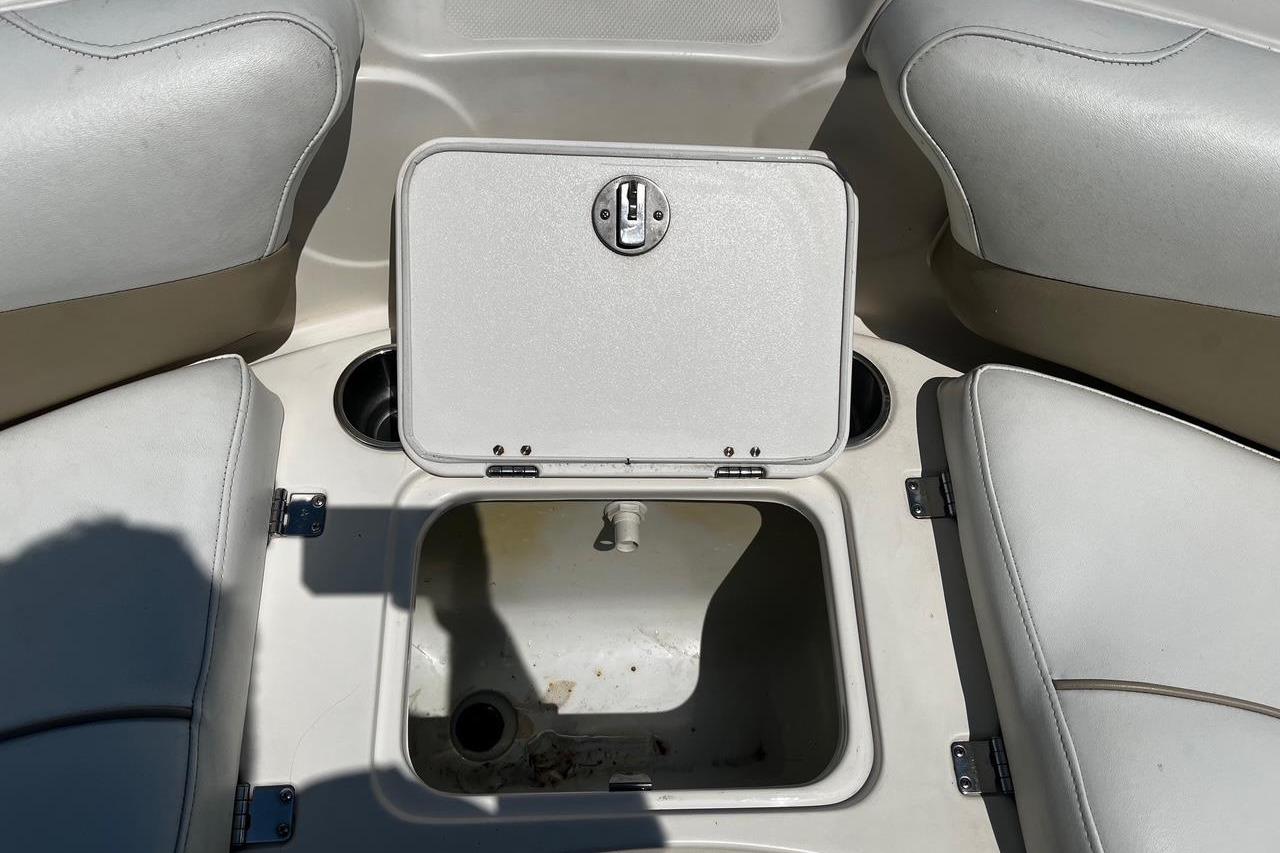 Open storage compartment on a 2008 Hurricane FD202 boat with cushioned seating.