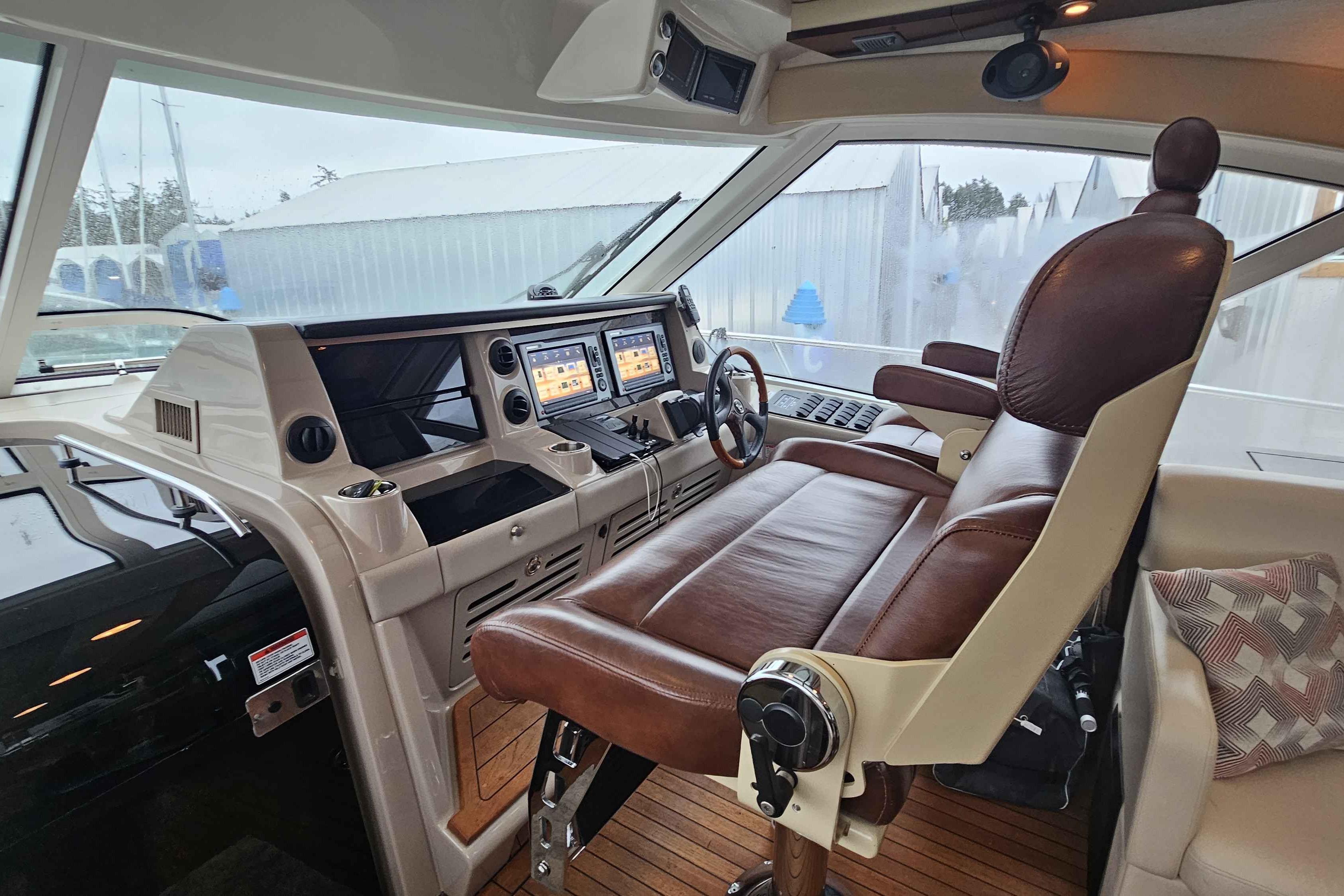 Luxurious helm of 2007 Sea Ray 60 Sundancer with leather seating and advanced controls.