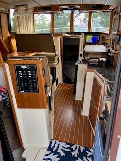 Interior of a 2023 Ranger Tugs R 31 le with wood flooring and modern amenities.
