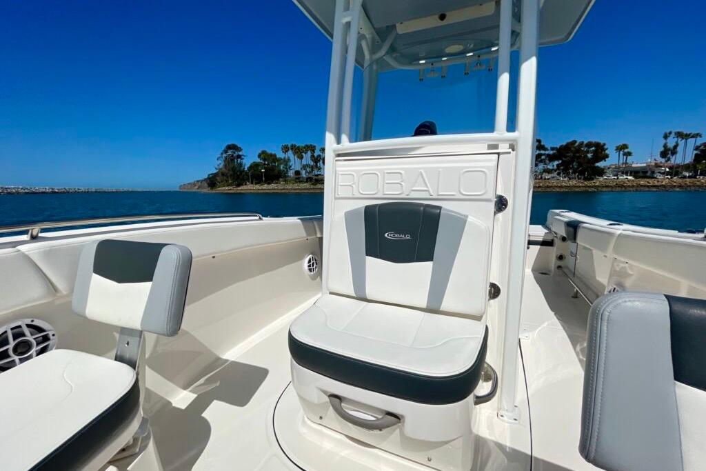 2022 Robalo R230 Center Console boat interior with seating, on a sunny day by the water.