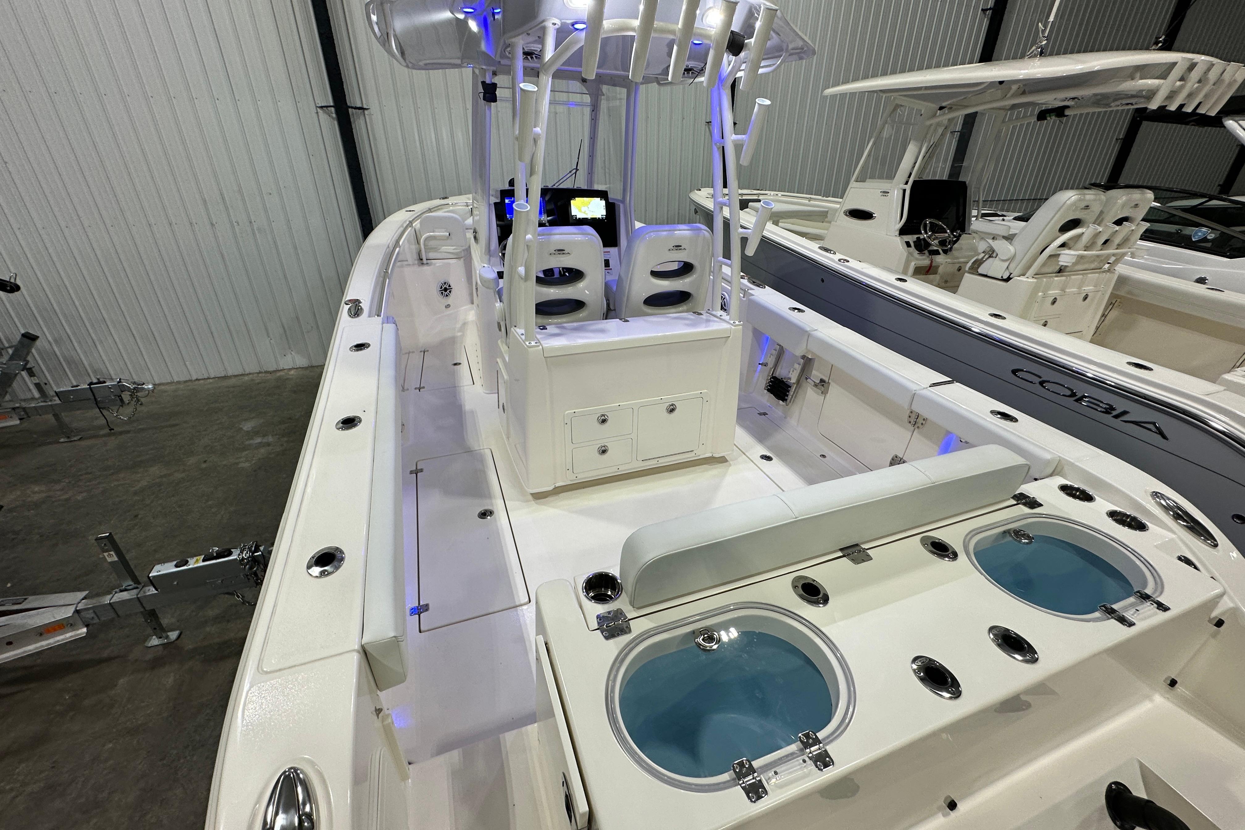 2024 Cobia 301 Center Console boat interior with seating and fishing amenities.