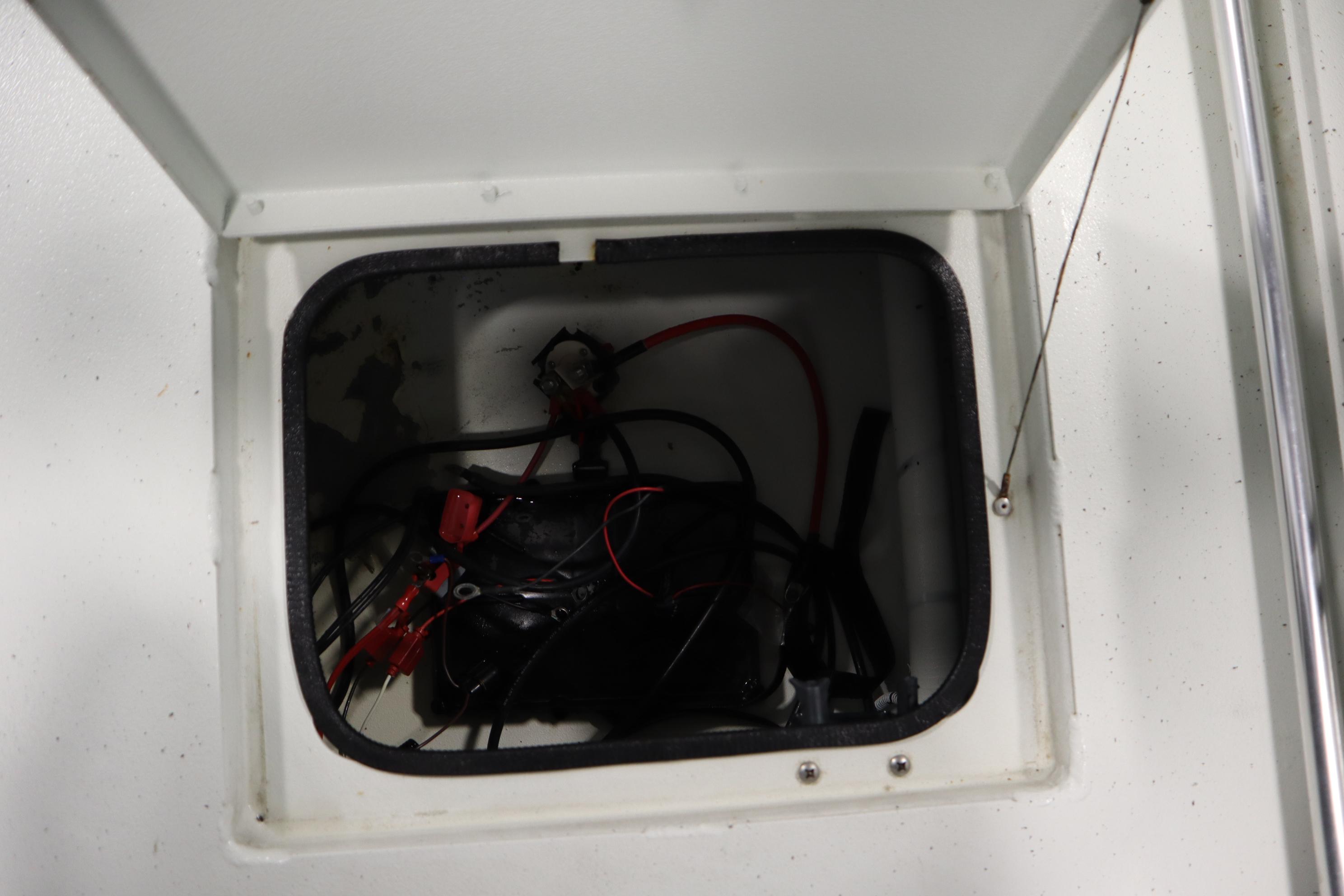 Open compartment with wiring inside a 2022 Crestliner 2200 CC boat.
