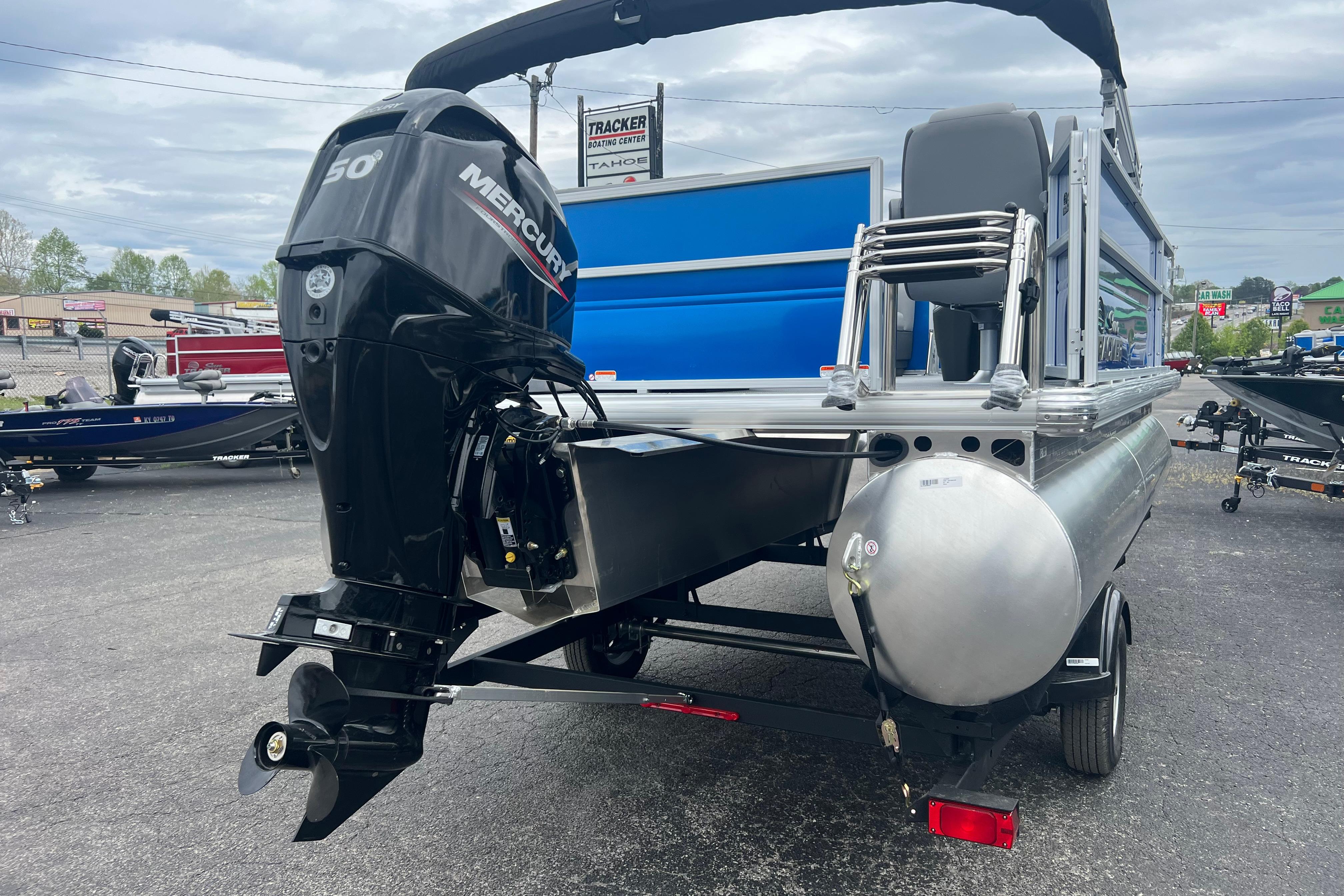 2026 Sun Tracker Party Barge 16 DLX with Mercury 50 engine, parked outdoors.