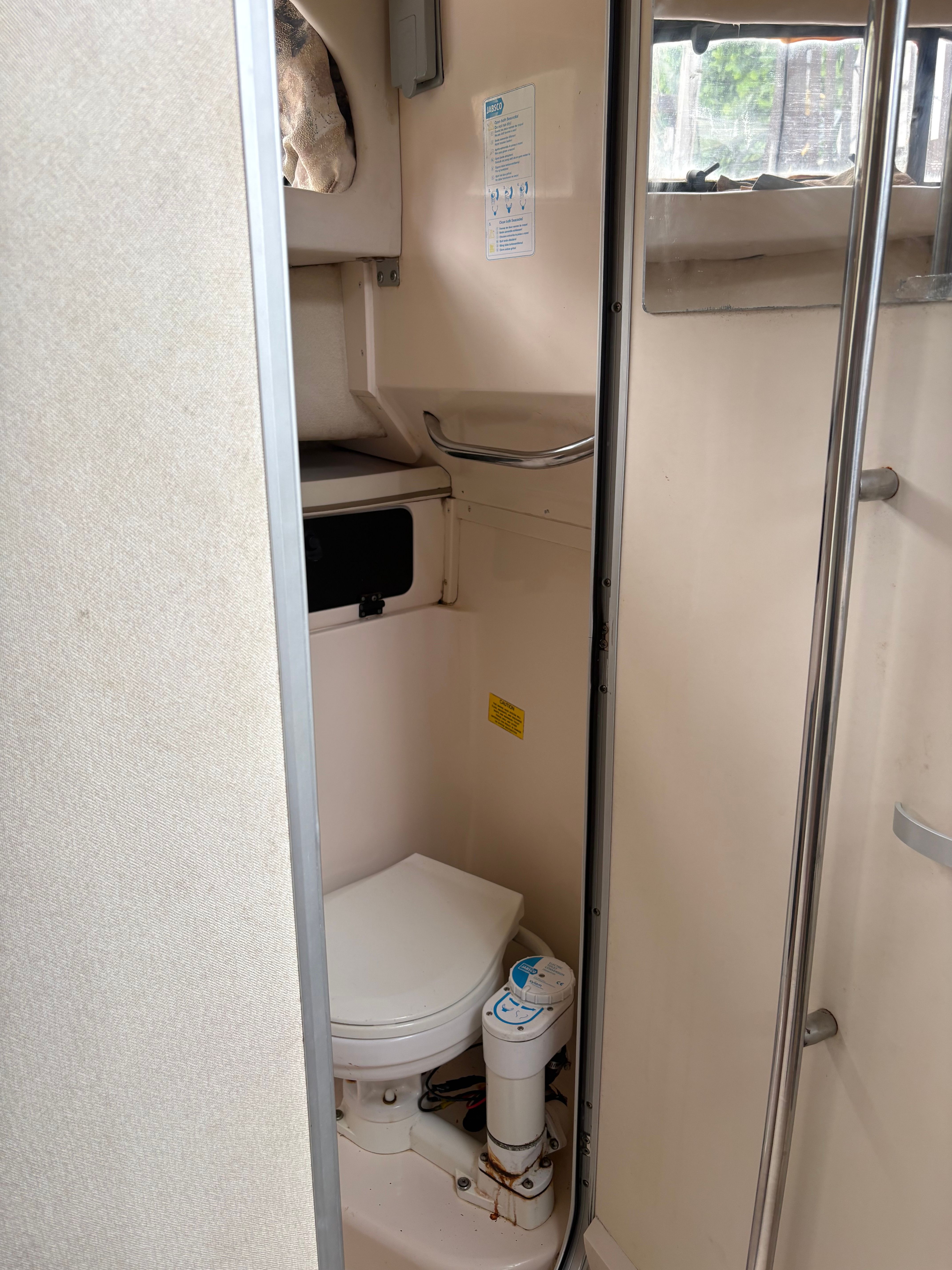 Interior view of the toilet on a 2001 Grady-White 30 Marlin boat.