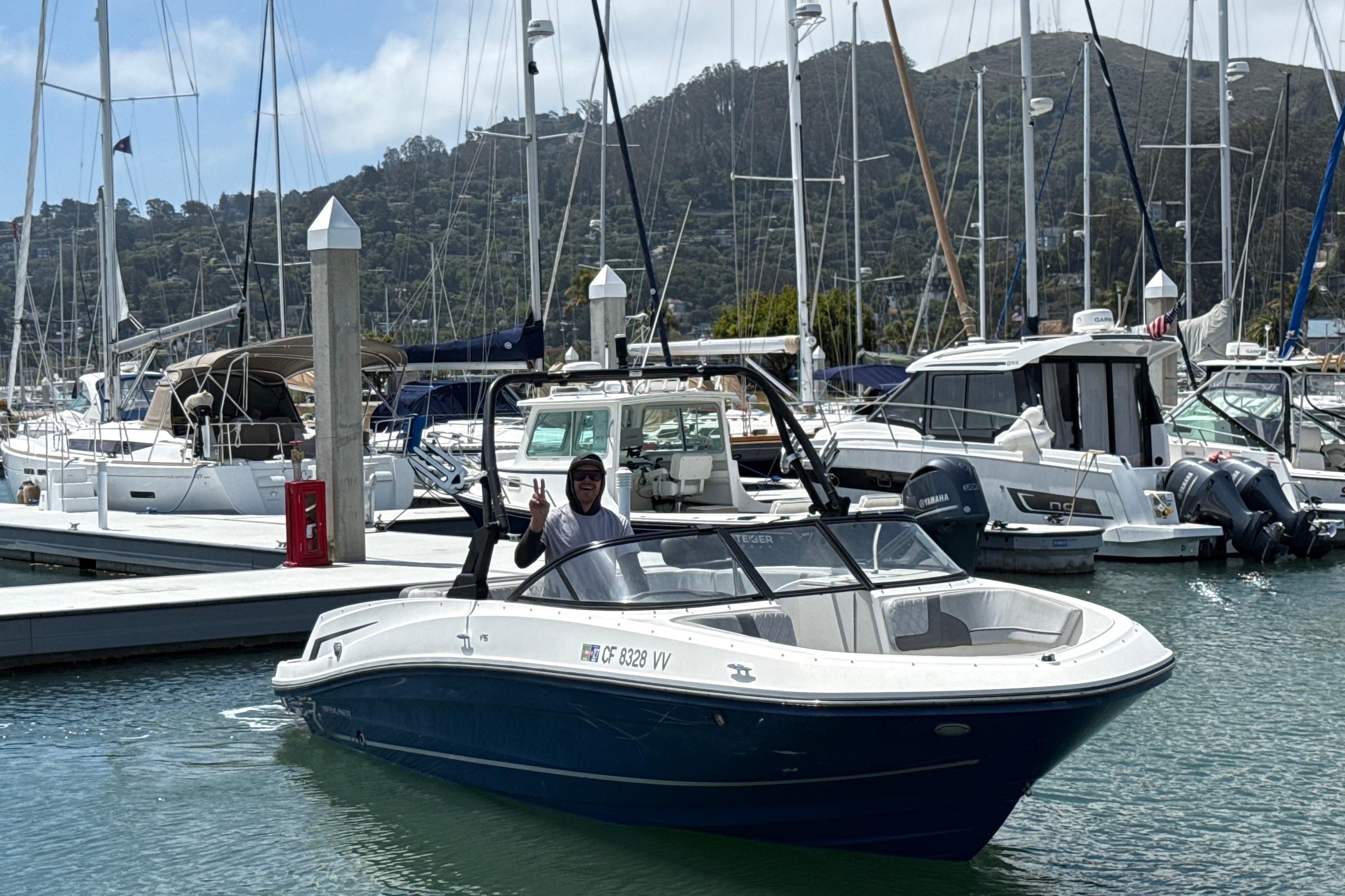 2021 Bayliner VR5 Bowrider I/O in marina, surrounded by sailboats and yachts.