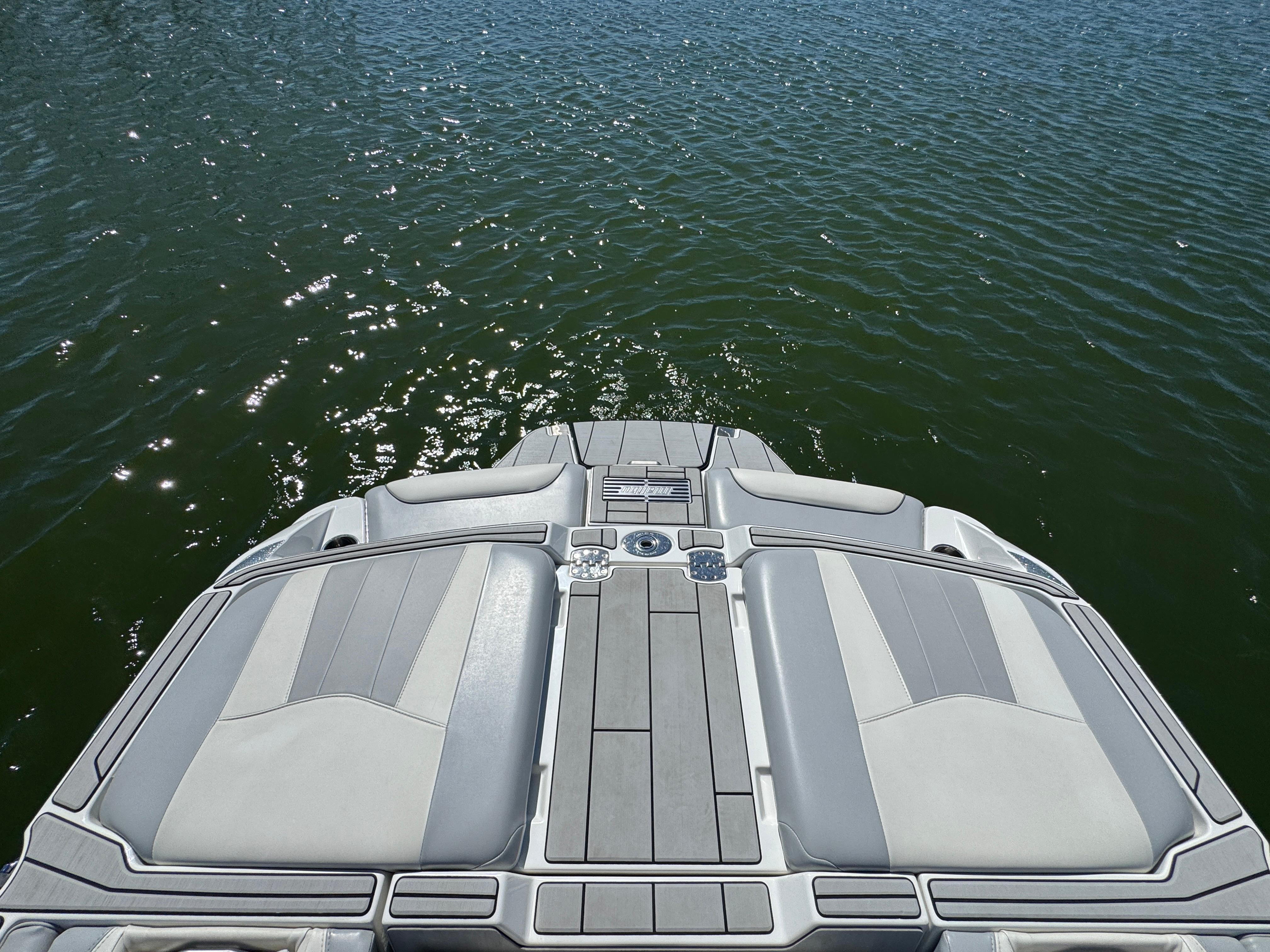 2022 Malibu Wakesetter 24 MXZ boat deck on calm water.