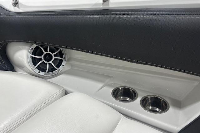 Interior of 2019 Crownline Eclipse E255 SURF boat with speaker and cup holders.
