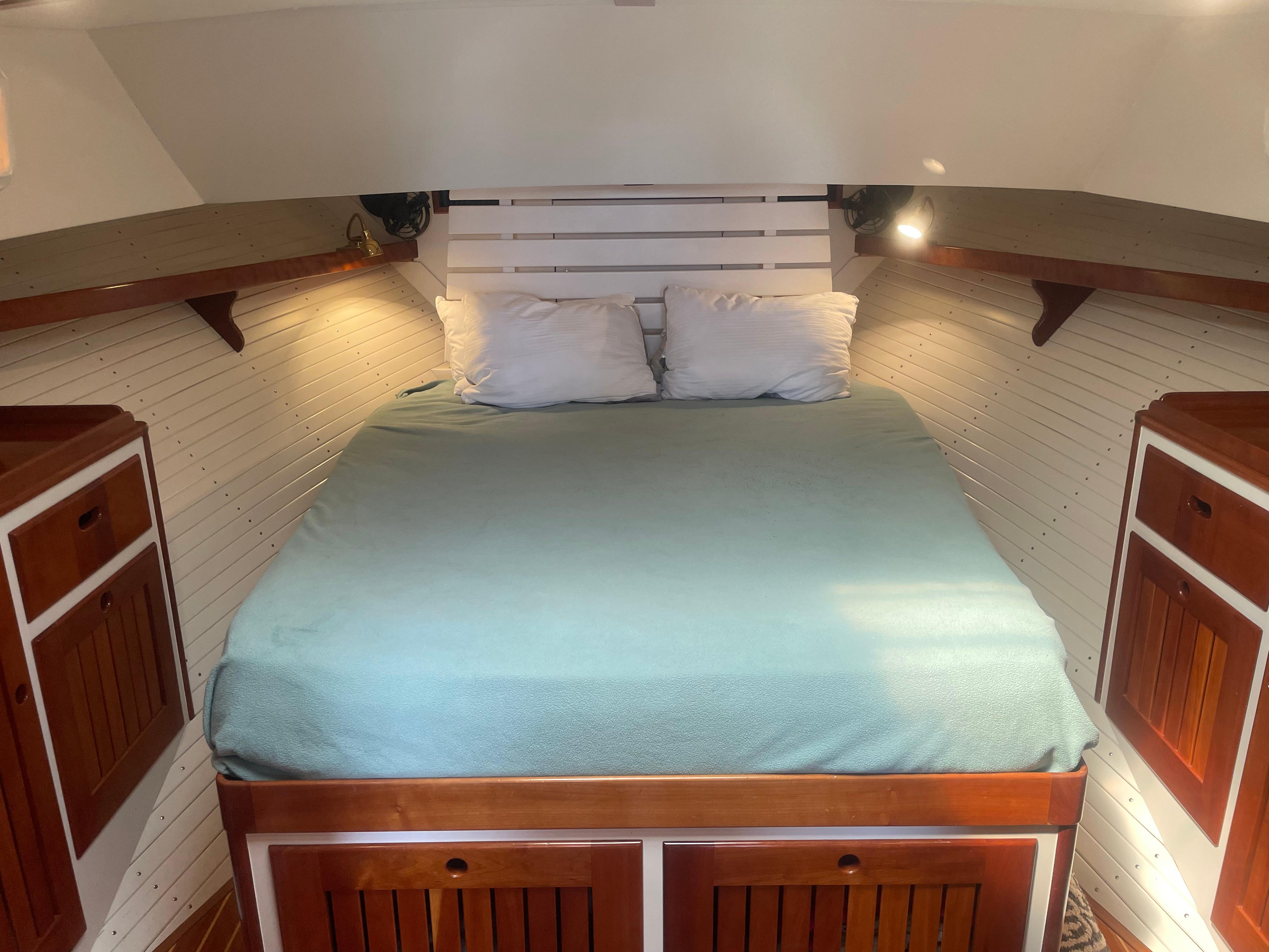 Cozy cabin interior of 1997 Lyman-Morse Custom Flybridge with wooden accents and a comfortable bed.